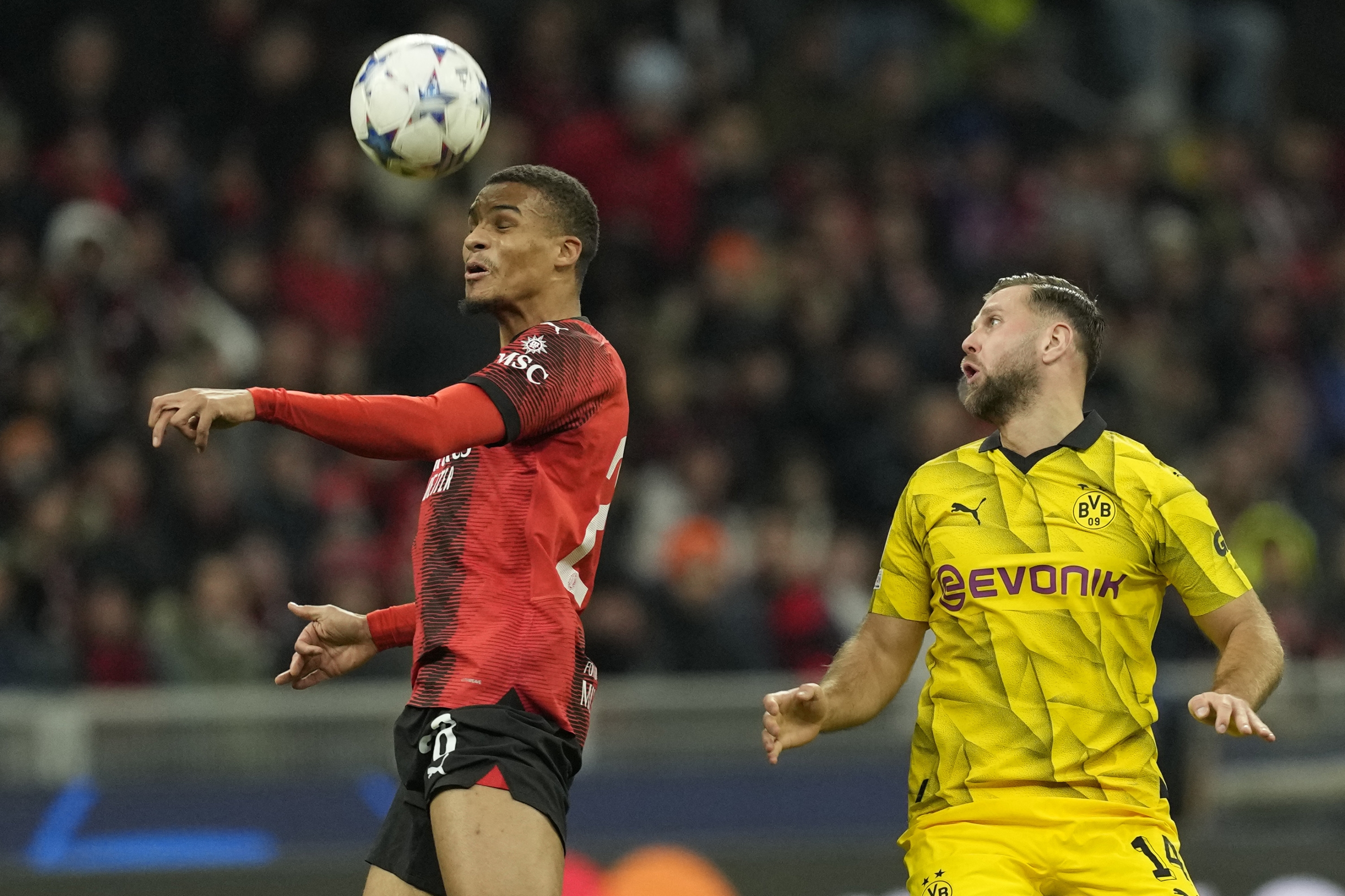 AC Milan's Malick Thiaw heads the ball during the Champions League group F soccer match between AC Milan and Borussia Dortmund at the San Siro stadium in Milan, Italy, Tuesday, Nov. 28, 2023. (AP Photo/Antonio Calanni)