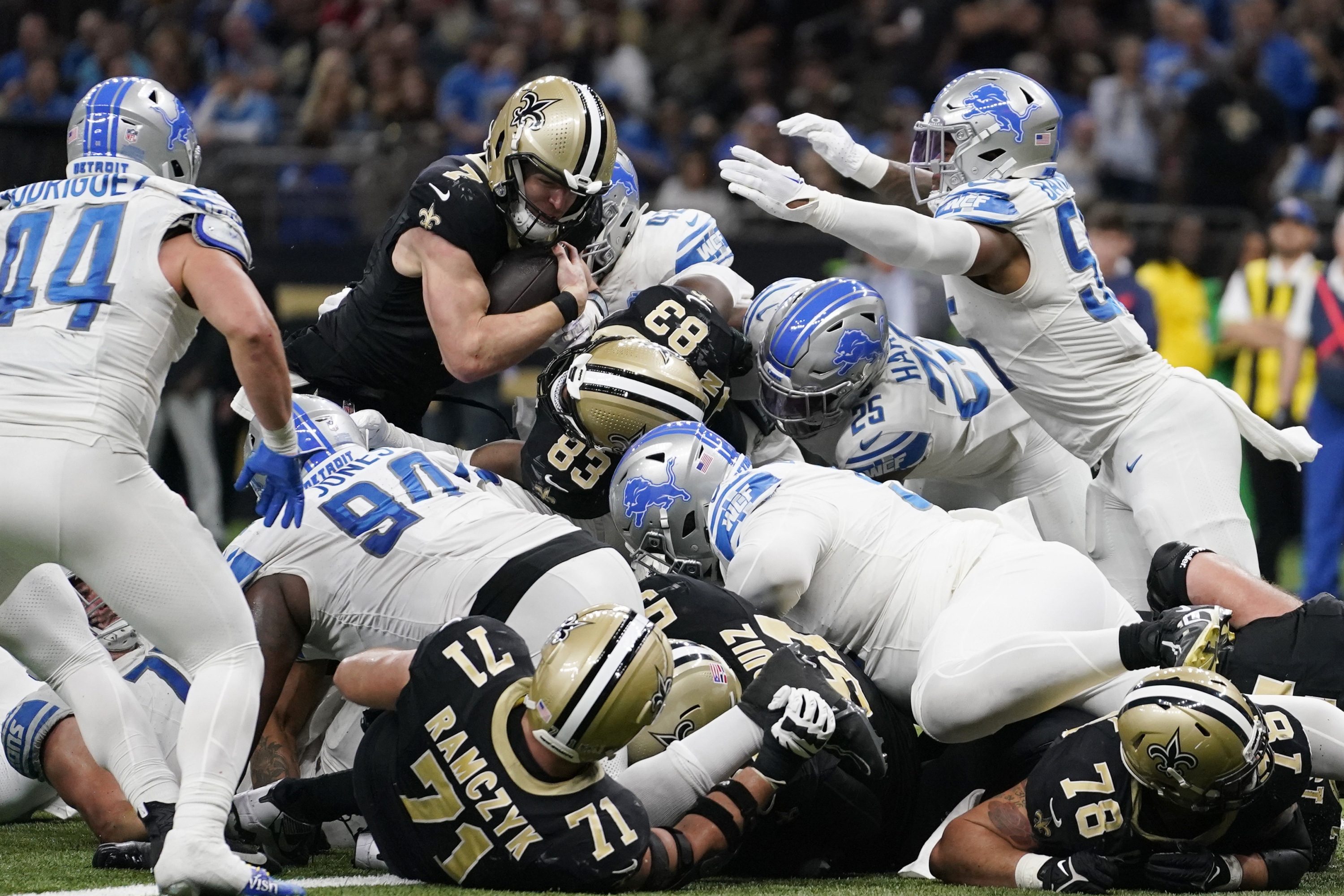 New Orleans Saints quarterback Taysom Hill (7) goes over the top for a 1-yard touchdown during the second half of an NFL football game against the Detroit Lions, Sunday, Dec. 3, 2023, in New Orleans. (AP Photo/Gerald Herbert)