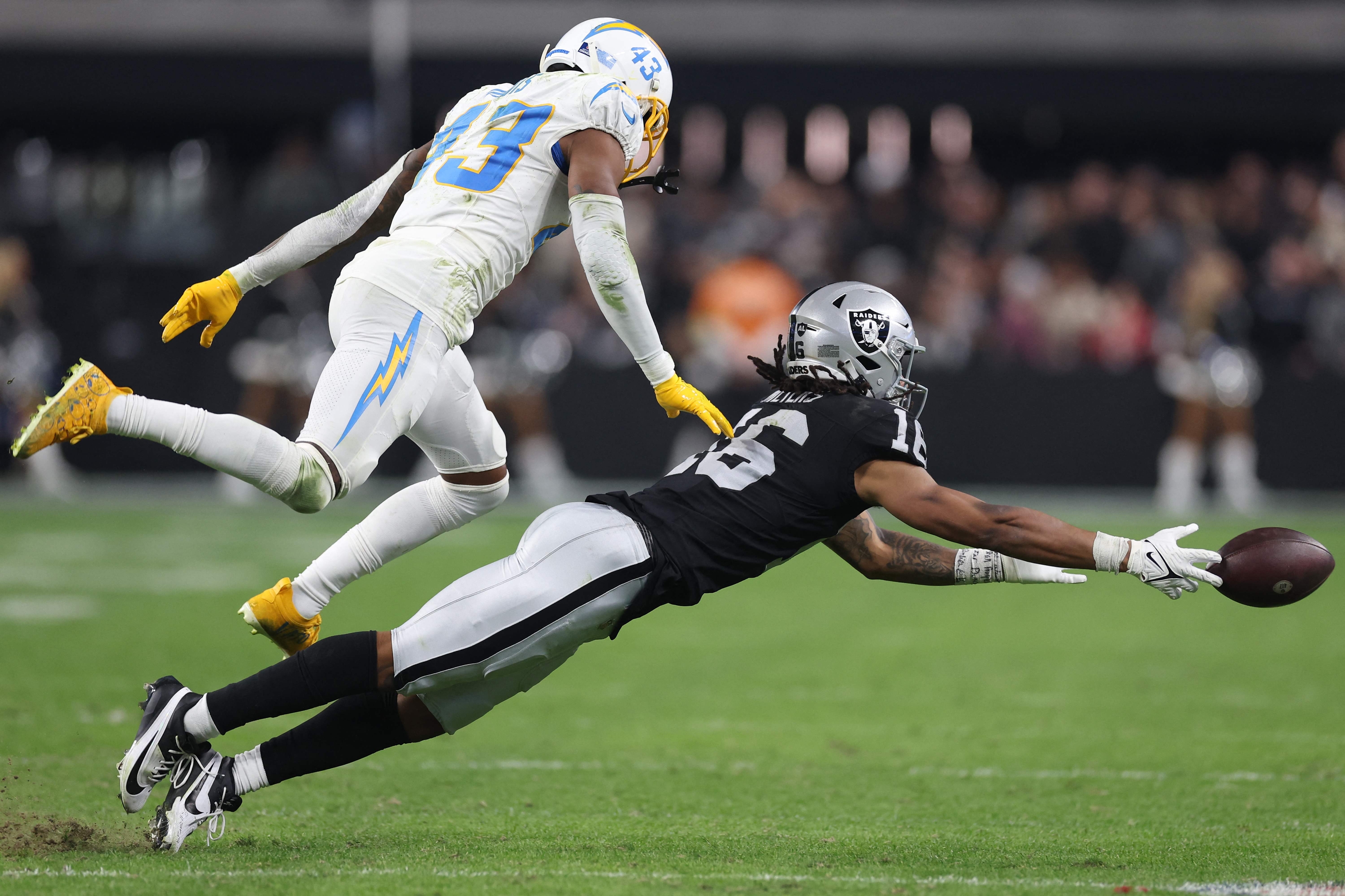 LAS VEGAS, NEVADA - DECEMBER 14: Wide receiver Jakobi Meyers #16 of the Las Vegas Raiders cannot make a catch in front of cornerback Michael Davis #43 of the Los Angeles Chargers during the second half at Allegiant Stadium on December 14, 2023 in Las Vegas, Nevada.   Sean M. Haffey/Getty Images/AFP (Photo by Sean M. Haffey / GETTY IMAGES NORTH AMERICA / Getty Images via AFP)