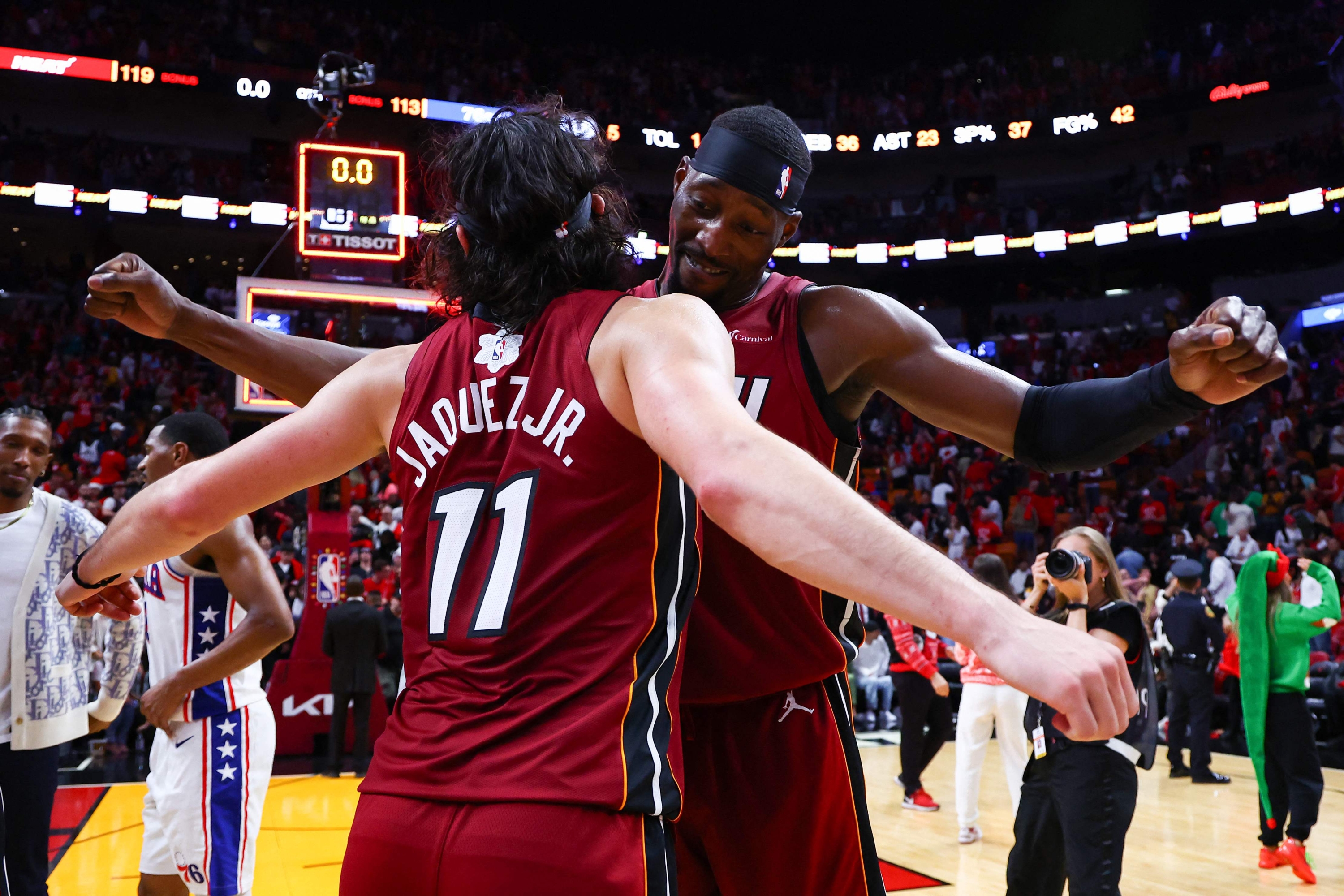 MIAMI, FLORIDA - DECEMBER 25: Jaime Jaquez Jr. #11 and Bam Adebayo #13 of the Miami Heat celebrate after defeating the Philadelphia 76ers at Kaseya Center on December 25, 2023 in Miami, Florida. NOTE TO USER: User expressly acknowledges and agrees that, by downloading and or using this photograph, User is consenting to the terms and conditions of the Getty Images License Agreement.   Megan Briggs/Getty Images/AFP (Photo by Megan Briggs / GETTY IMAGES NORTH AMERICA / Getty Images via AFP)