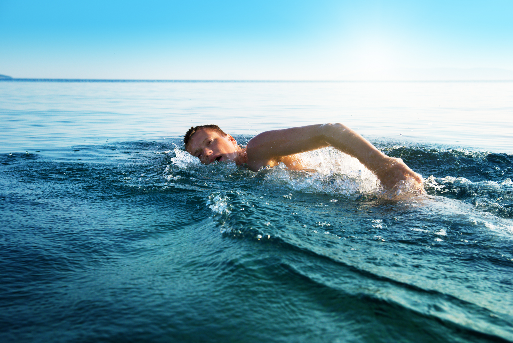 young man swiming in oceans water