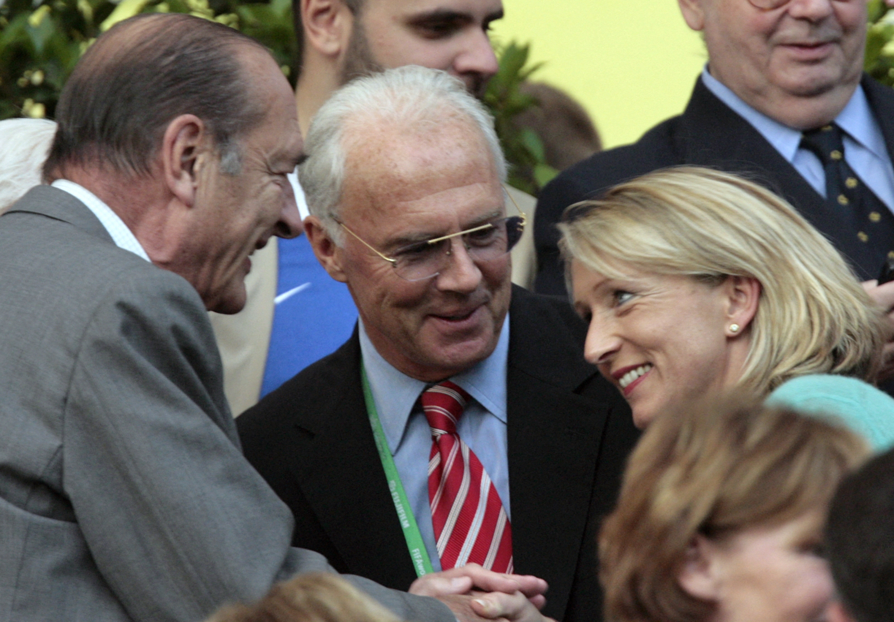 (FILES) French President Jacques Chirac (L) meets Heidi (R), the wife of World Cup 2006 organising committee chief Franz Beckenbauer (C) before the start of the quarter-final World Cup football match between Brazil and France at Frankfurt's World Cup Stadium, 01 July 2006. German football legend Franz Beckenbauer, world champion as a player in 1974 and as coach in 1990, died on Sunday at the age of 78, the German Federation (DFB) announced on January 8, 2024 to the SID press agency, subsidiary of the AFP. (Photo by PASCAL PAVANI / AFP)