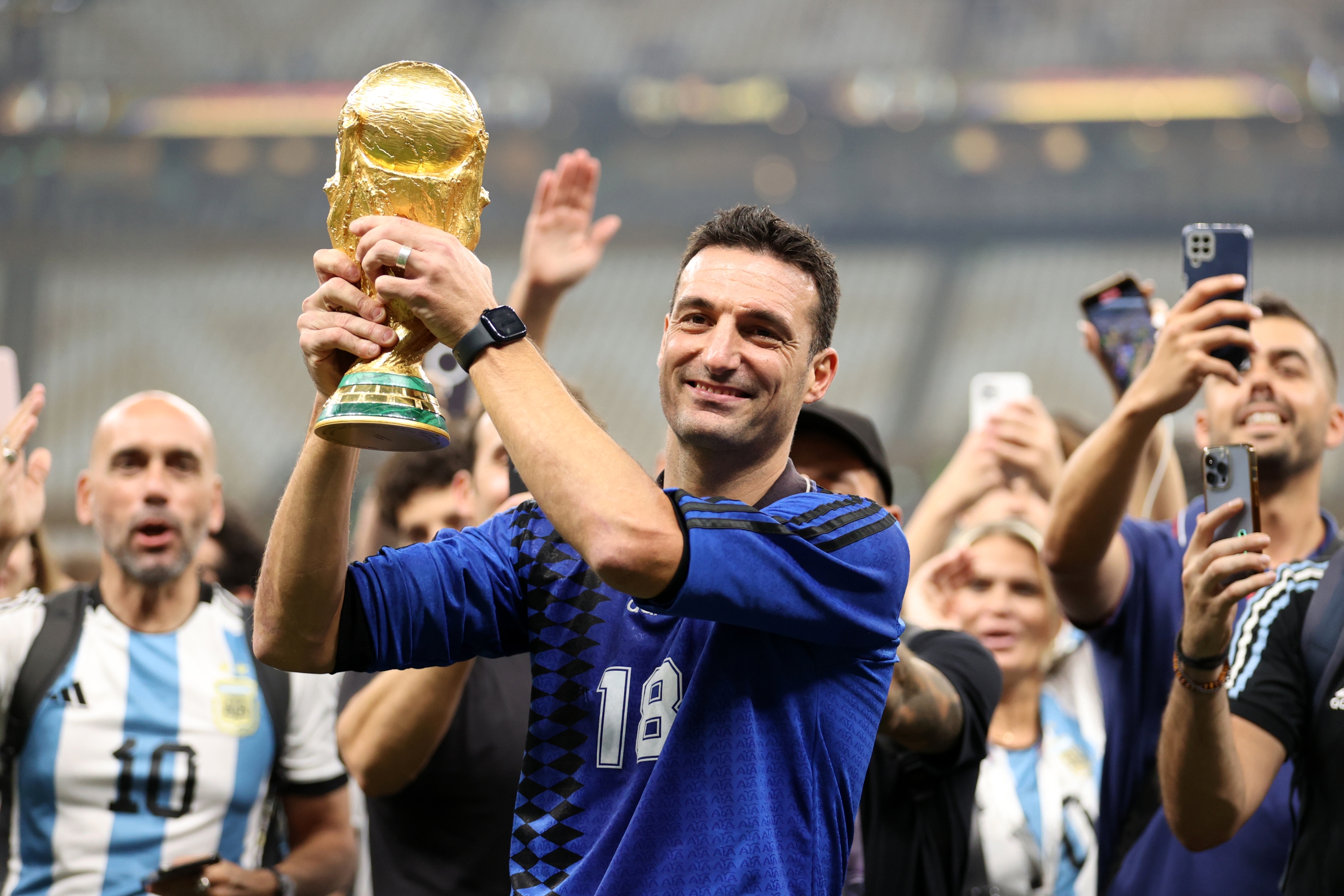LUSAIL CITY, QATAR - DECEMBER 18: Lionel Scaloni, Head Coach of Argentina, celebrates with the FIFA World Cup Qatar 2022 Winner's Trophy after the team's victory during the FIFA World Cup Qatar 2022 Final match between Argentina and France at Lusail Stadium on December 18, 2022 in Lusail City, Qatar. (Photo by Julian Finney/Getty Images)