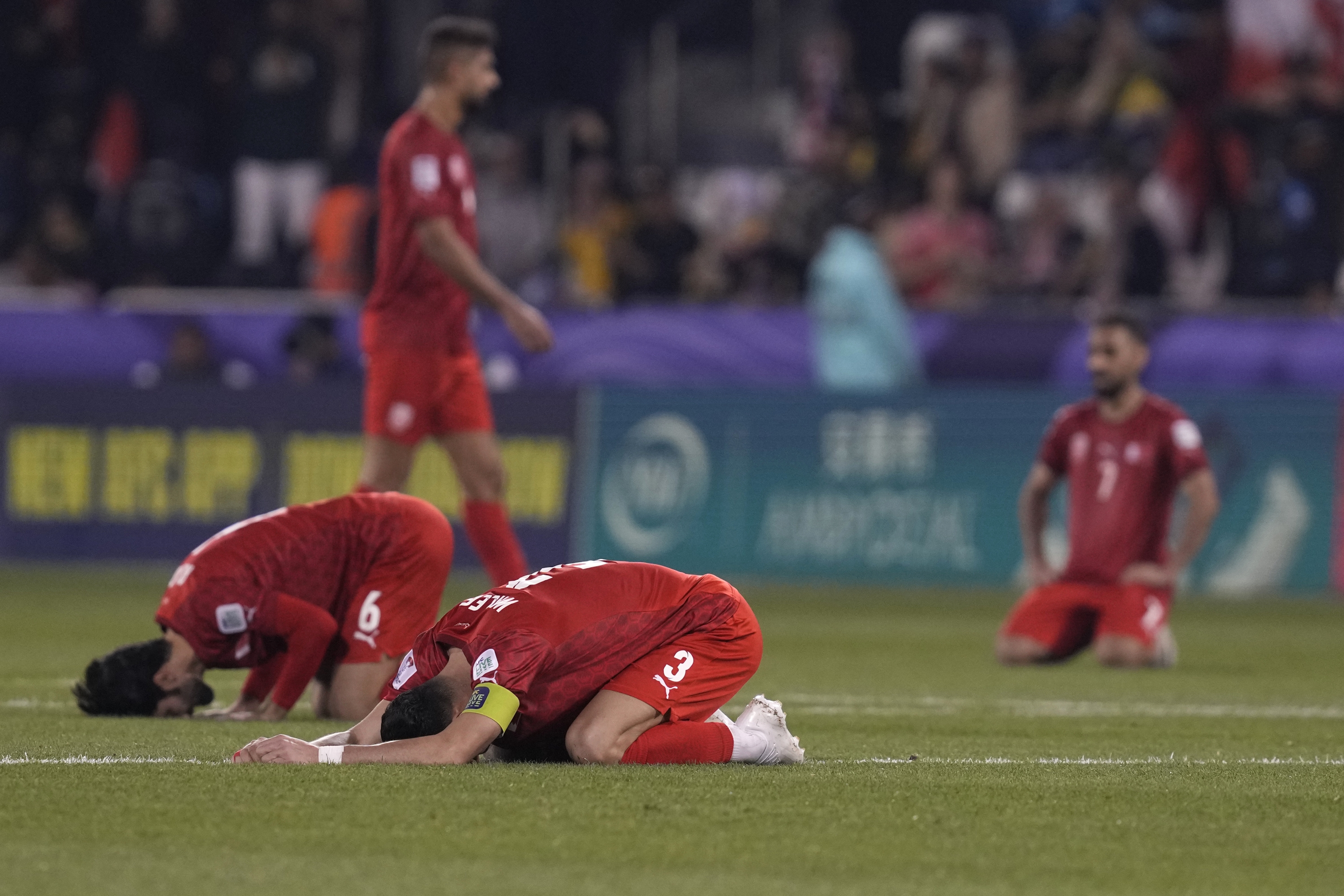 Bahrain's Waleed Alhayam, front, and teammates react after their win in the Asian Cup Group E soccer match between Malaysia and Bahrain at Jassim bin Hamad Stadium in Doha, Qatar, Saturday, Jan. 20, 2024. (AP Photo/Thanassis Stavrakis)
