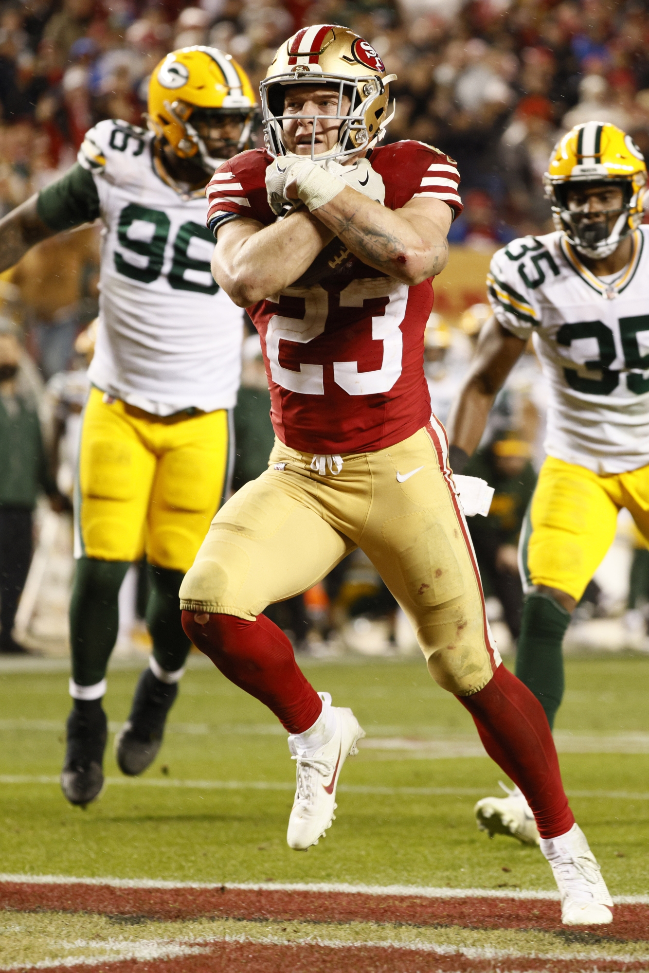 San Francisco 49ers running back Christian McCaffrey (23) scores a touchdown against the Green Bay Packers during the fourth quarter of an NFL football NFC divisional playoff game Saturday, Jan. 20, 2024, in Santa Clara, Calif. (Santiago Mejia/San Francisco Chronicle via AP)