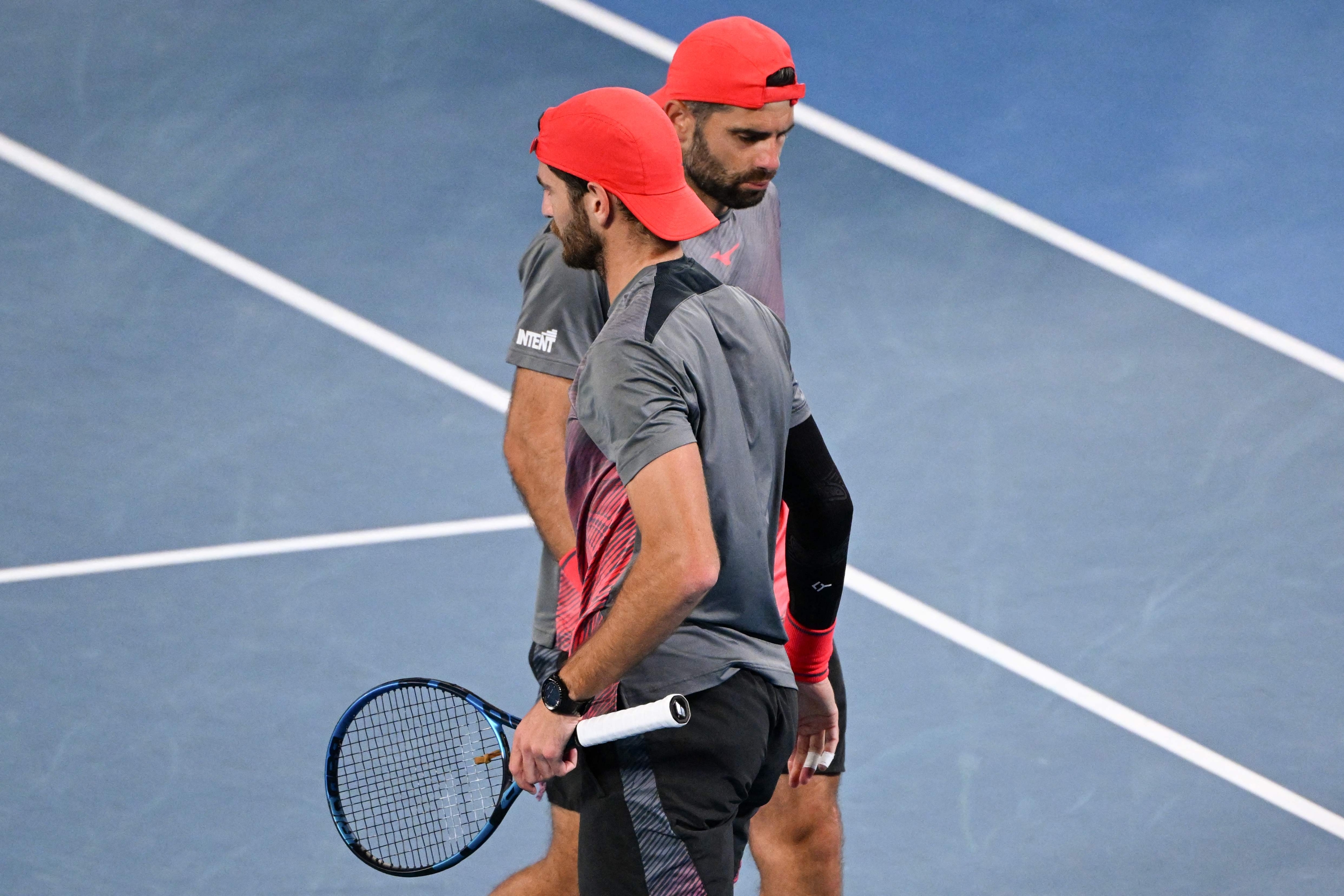 Italy's Simone Bolelli (R) and Andrea Vavassori prepare to play a point against India's Rohan Bopanna and Australia's Matthew Ebden during their men's doubles final match on day 14 of the Australian Open tennis tournament in Melbourne on January 27, 2024. (Photo by WILLIAM WEST / AFP) / -- IMAGE RESTRICTED TO EDITORIAL USE - STRICTLY NO COMMERCIAL USE --
