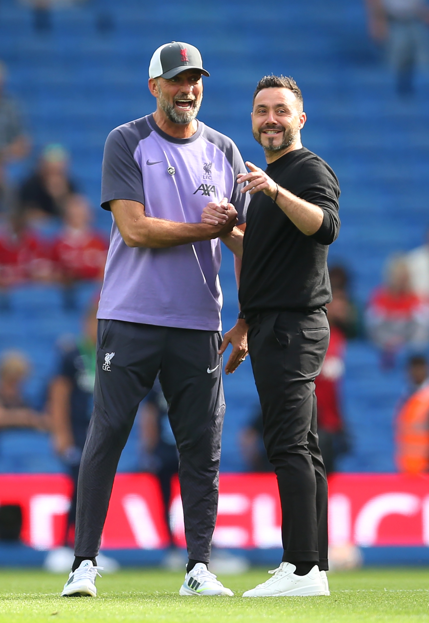 BRIGHTON, ENGLAND - OCTOBER 08: Juergen Klopp, Manager of Liverpool, talks to Roberto De Zerbi, Manager of Brighton & Hove Albion, as the teams warm up prior to the Premier League match between Brighton & Hove Albion and Liverpool FC at American Express Community Stadium on October 08, 2023 in Brighton, England. (Photo by Steve Bardens/Getty Images)