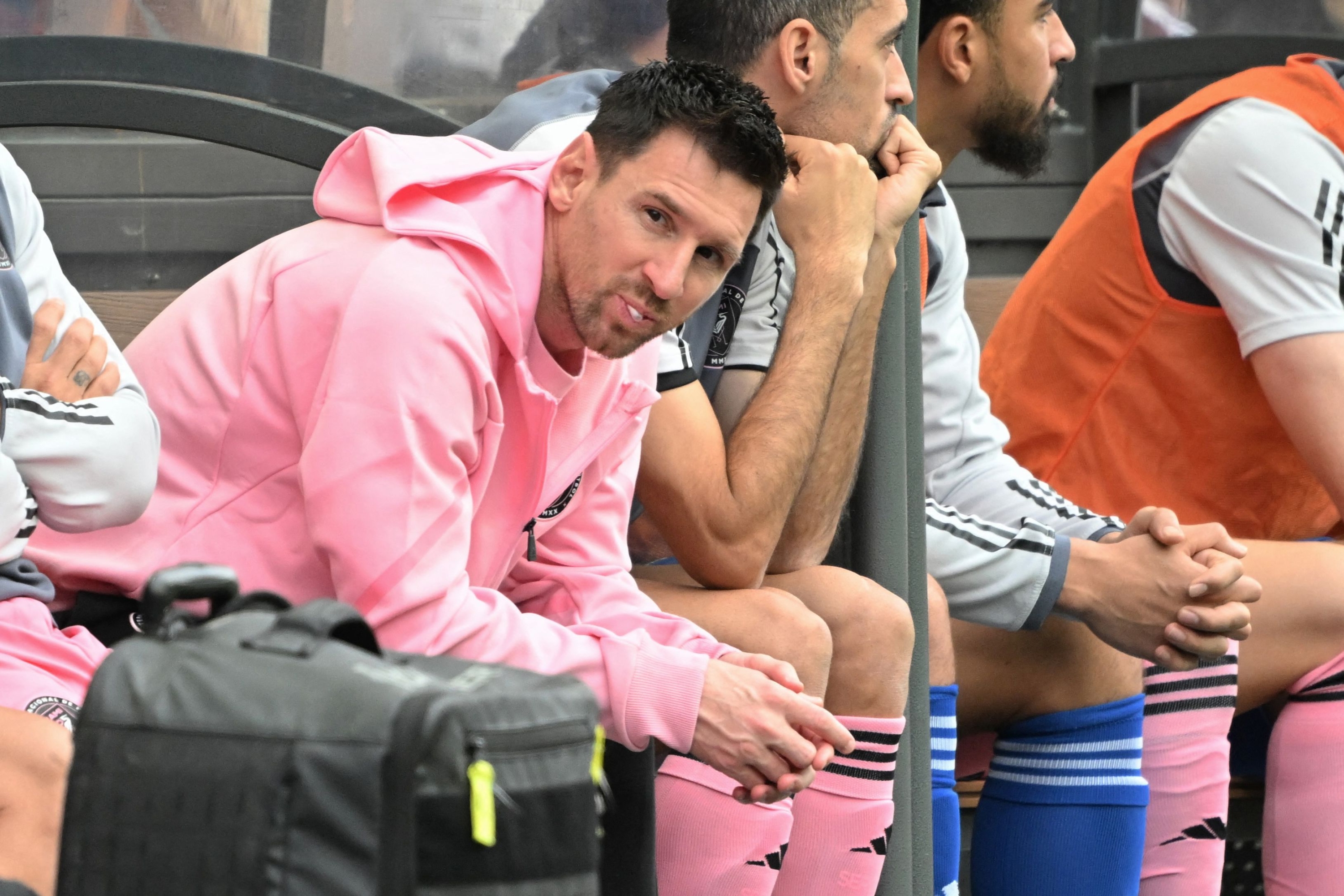 TOPSHOT - Inter Miami's Argentine forward Lionel Messi (L) sits on the bench during the friendly football match between Hong Kong XI and US Inter Miami CF in Hong Kong on February 4, 2024. Inter Miami were booed off the pitch after their injured superstar Lionel Messi failed to take the field in a pre-season friendly in Hong Kong. (Photo by Peter PARKS / AFP)