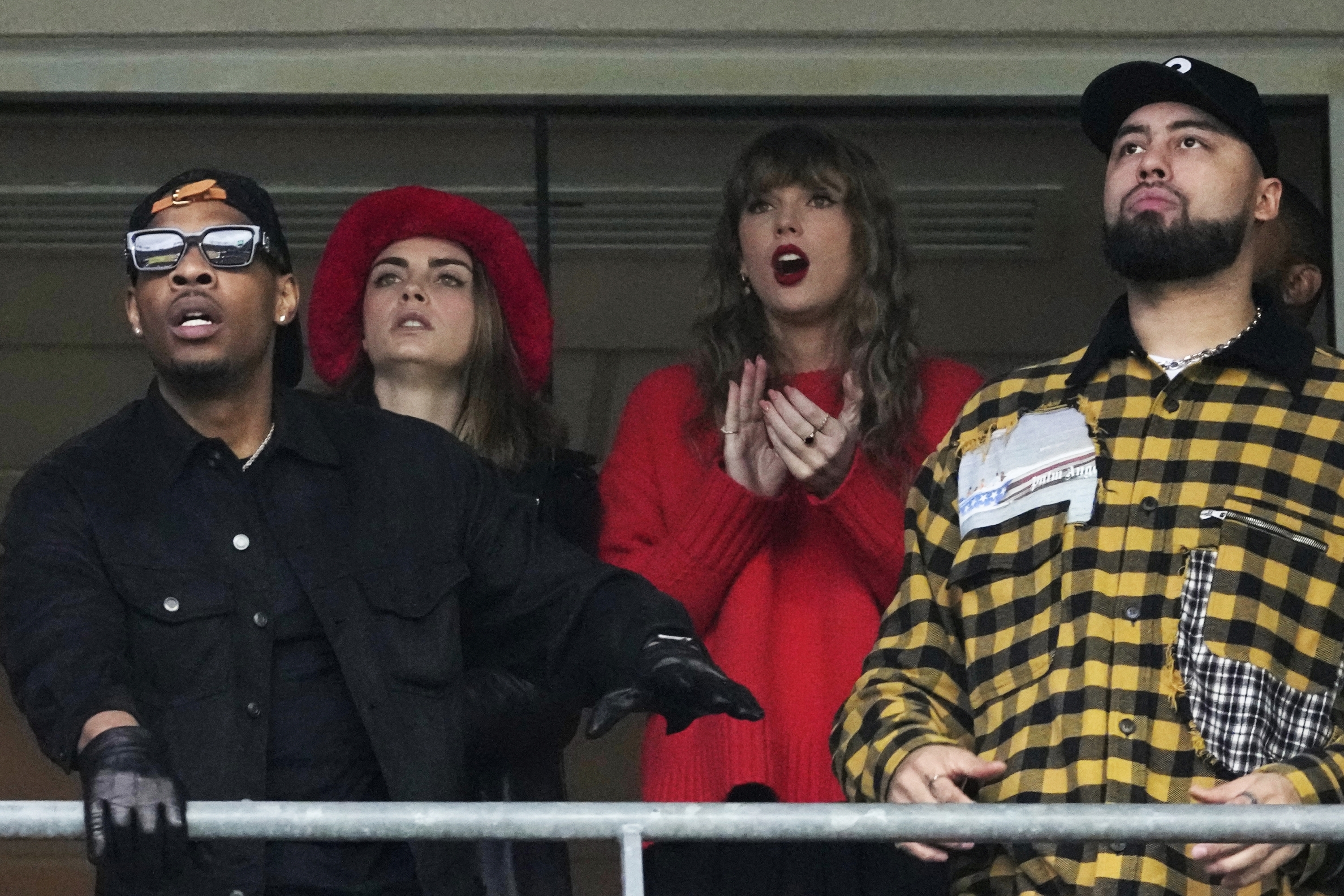 Taylor Swift, center, reacts during the first half of the AFC Championship NFL football game between the Baltimore Ravens and the Kansas City Chiefs, Sunday, Jan. 28, 2024, in Baltimore. (AP Photo/Nick Wass)