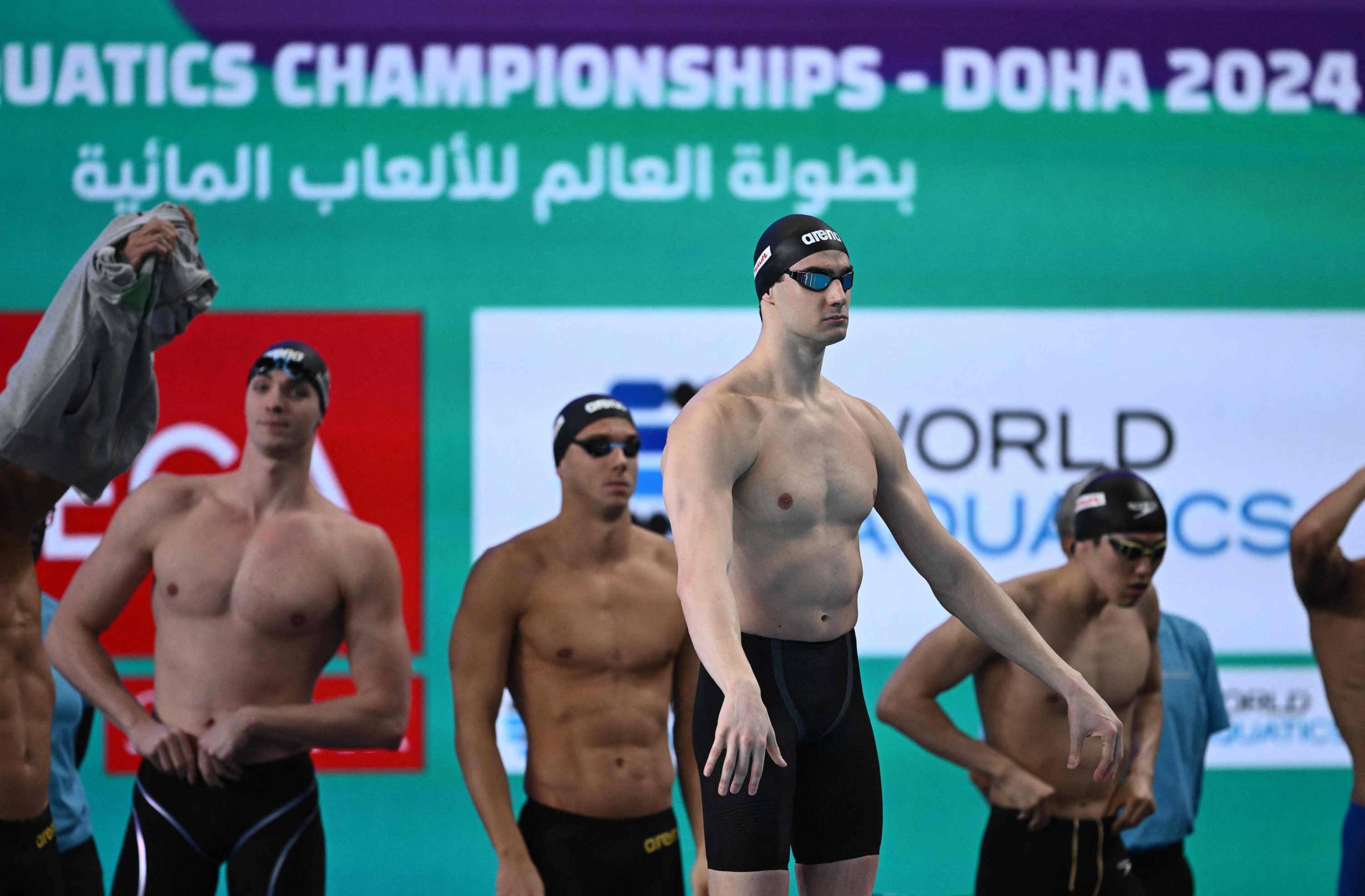 Italy's Lorenzo Zazzeri lines up for a heat during the men's 4X100m freestyle relay swimming event during the 2024 World Aquatics Championships at Aspire Dome in Doha on February 11, 2024. (Photo by SEBASTIEN BOZON / AFP)