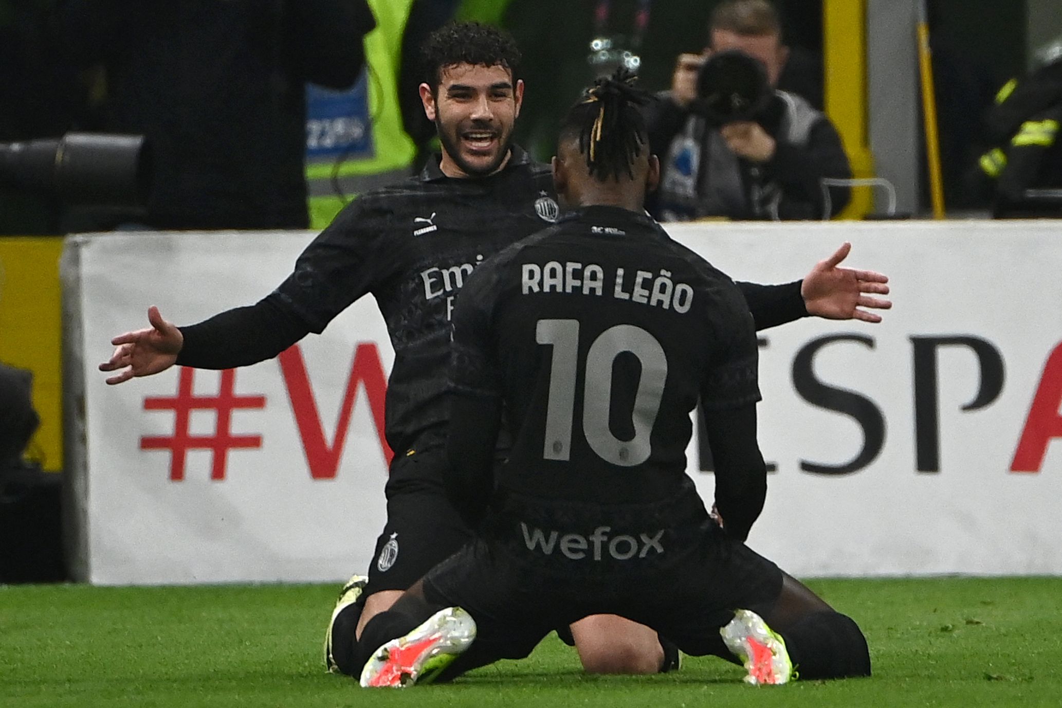AC Milan's French defender #19 Theo Hernandez (front) celebrates with his teammate AC Milan's Portuguese forward #10 Rafael Leao after scoring during the Italian Serie A football match between AC Milan and Napoli at the San Siro Stadium, in Milan on February 11, 2024. (Photo by Isabella BONOTTO / AFP)