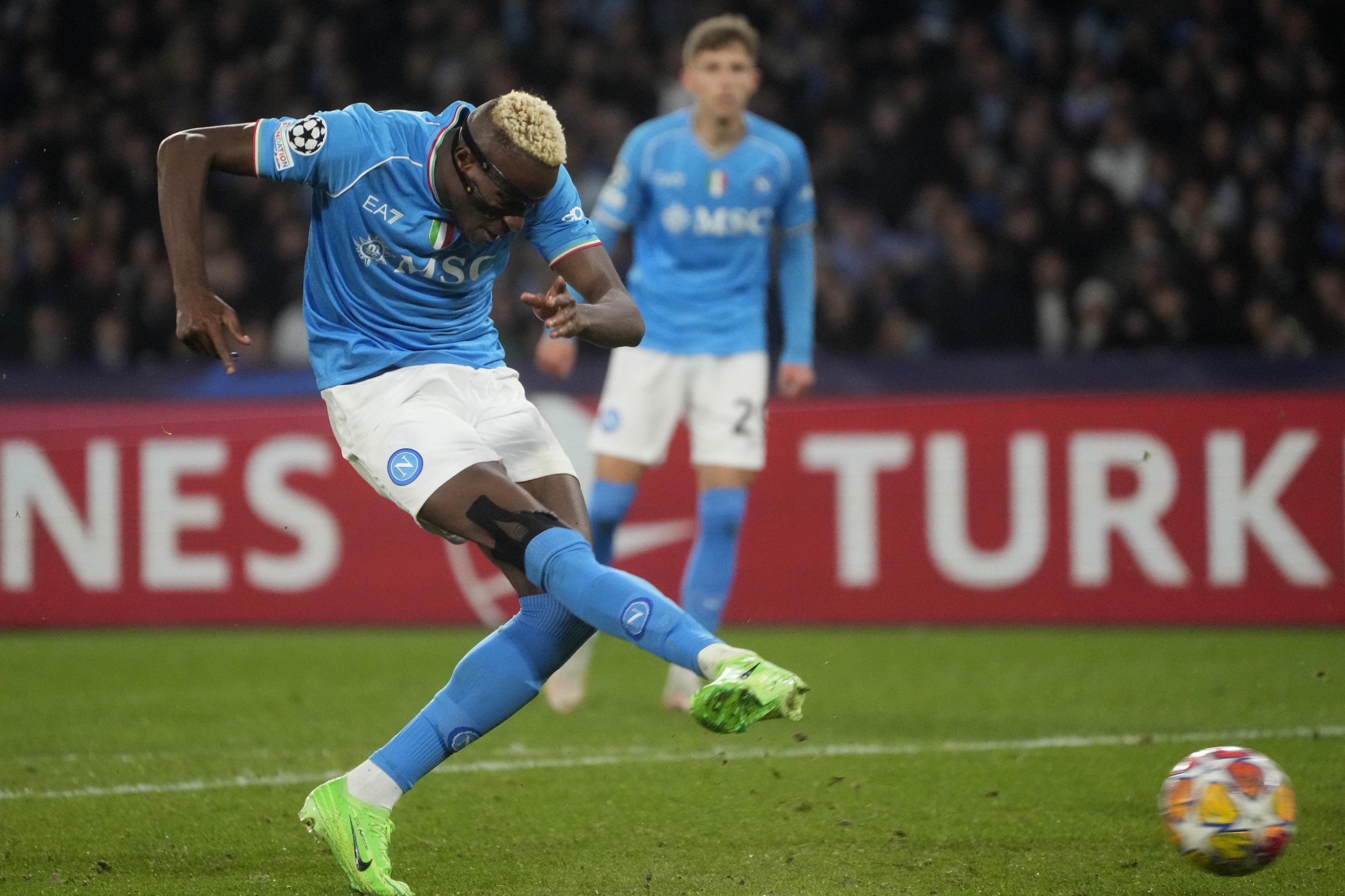 Napoli's Victor Osimhen scores his side's opening goal during the Champions League, round of 16, first leg soccer match between SSC Napoli and FC Barcelona at the Diego Maradona stadium in Naples, Italy, Wednesday, Feb. 21, 2024. (AP Photo/Gregorio Borgia)