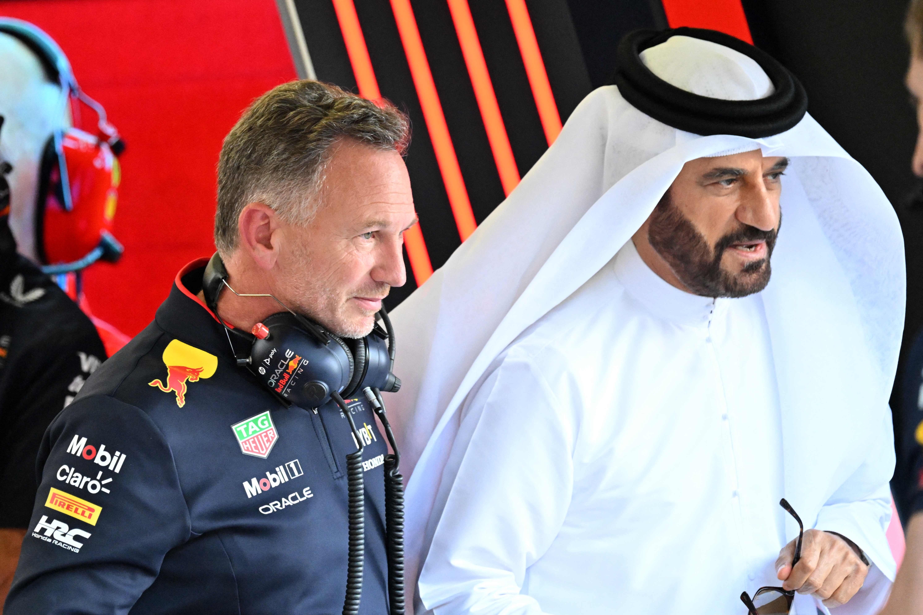 Red Bull Racing team principal Christian Horner (L) speaks to FIA president Mohammed bin Sulayem during the third practice session of the Bahrain Formula One Grand Prix at the Bahrain International Circuit in Sakhir on March 1, 2024. (Photo by ANDREJ ISAKOVIC / AFP)