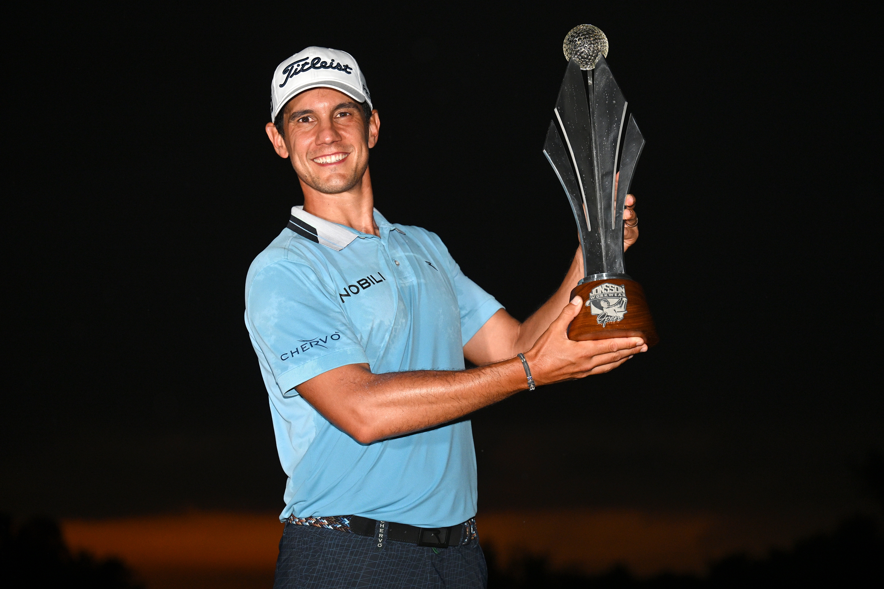JOHANNESBURG, SOUTH AFRICA - MARCH 10: Matteo Manassero of Italy is awarded the trophy as he celebrates victory following day four of the Jonsson Workwear Open at Glendower Golf Club on March 10, 2024 in Johannesburg, South Africa. (Photo by Stuart Franklin/Getty Images)