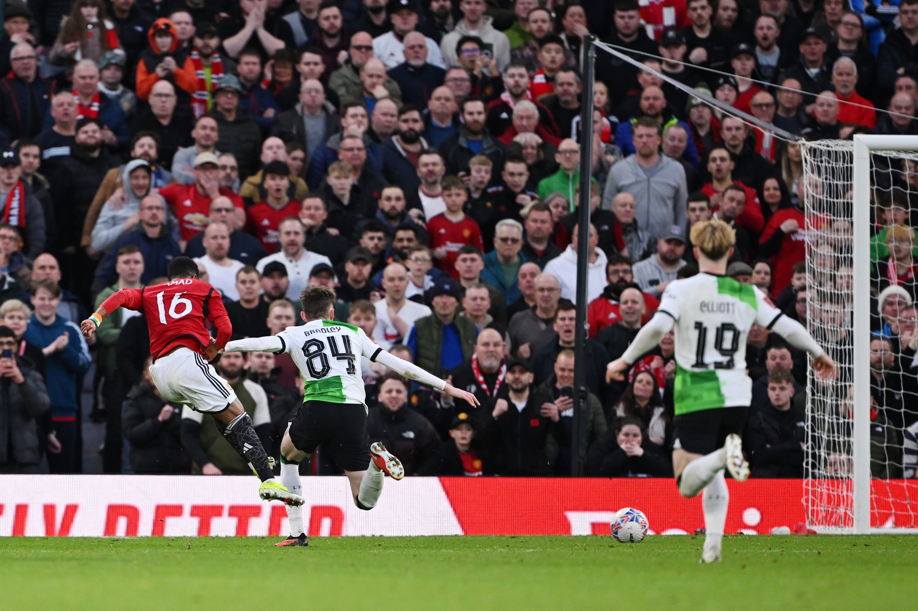 MANCHESTER, ENGLAND - MARCH 17: Amad Diallo of Manchester United scores his team's fourth goal whilst under pressure from Conor Bradley of Liverpool during the Emirates FA Cup Quarter Final between Manchester United and Liverpool FC at Old Trafford on March 17, 2024 in Manchester, England. (Photo by Stu Forster/Getty Images)