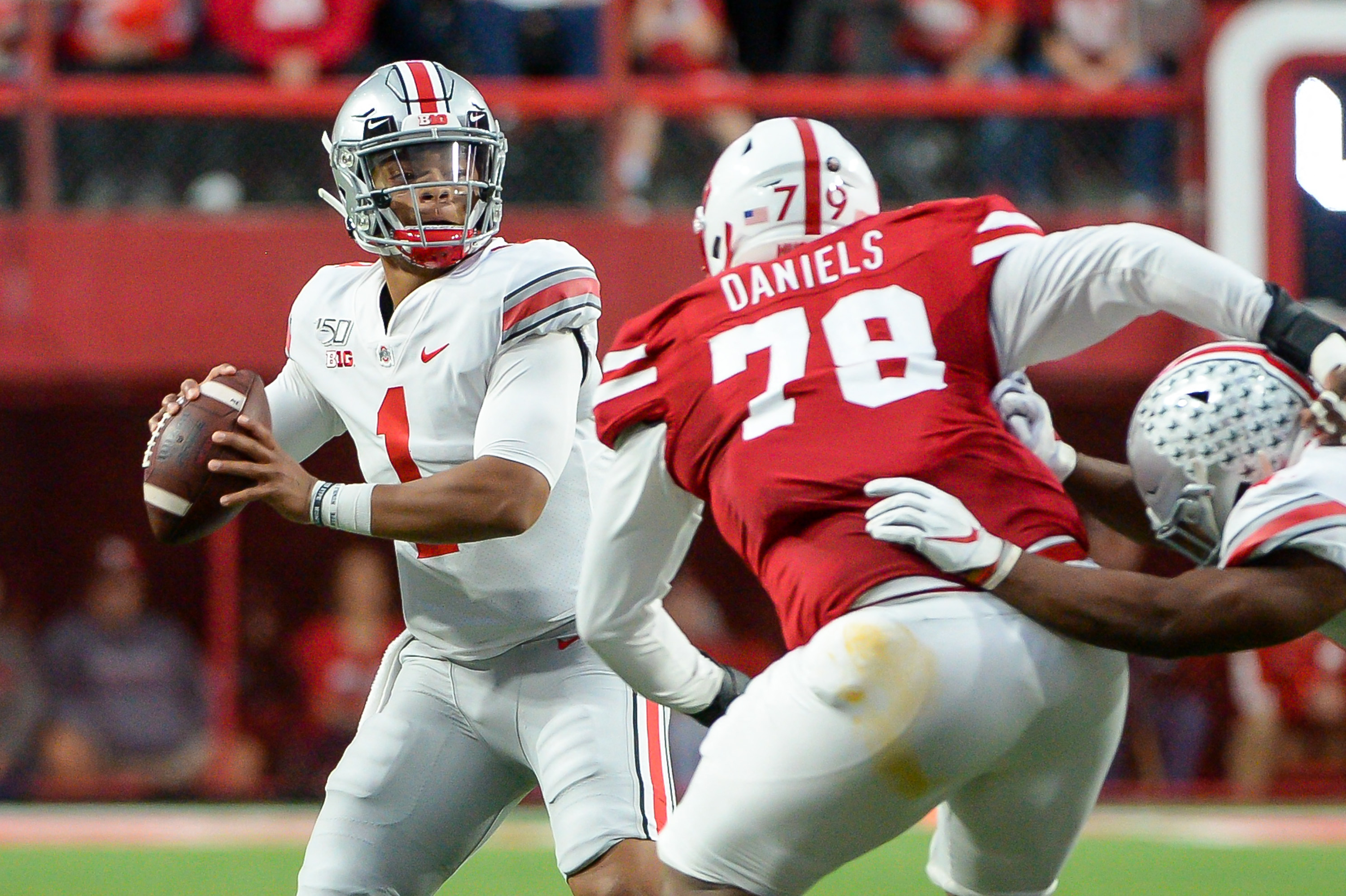 LINCOLN, NE - SEPTEMBER 28: Quarterback Justin Fields #1 of the Ohio State Buckeyes passes ahead of the rush from defensive lineman Darrion Daniels #79 of the Nebraska Cornhuskers at Memorial Stadium on September 28, 2019 in Lincoln, Nebraska.   Steven Branscombe/Getty Images/AFP (Photo by Steven Branscombe / GETTY IMAGES NORTH AMERICA / Getty Images via AFP)