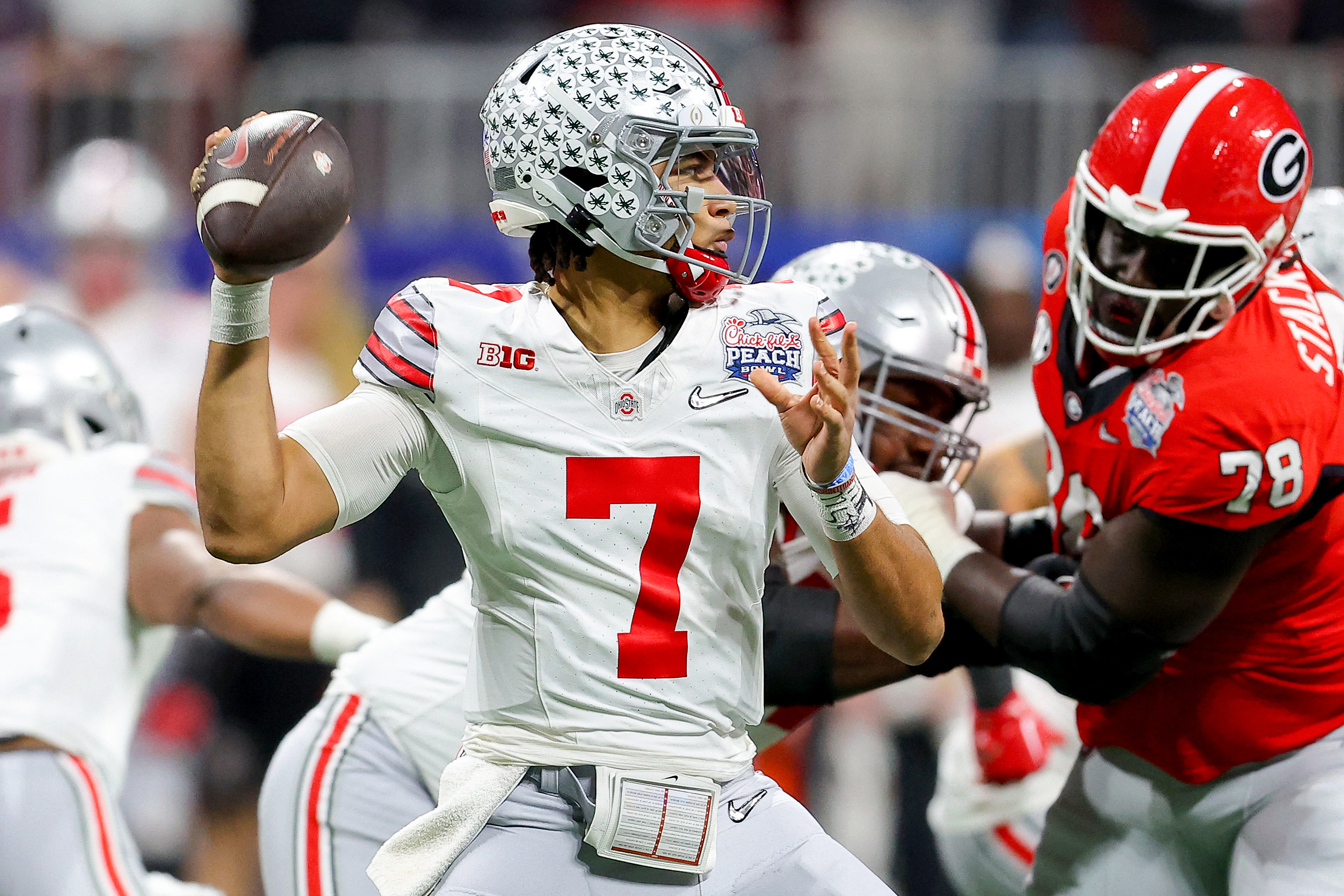 ATLANTA, GEORGIA - DECEMBER 31: C.J. Stroud #7 of the Ohio State Buckeyes looks to pass during the first quarter against the Georgia Bulldogs in the Chick-fil-A Peach Bowl at Mercedes-Benz Stadium on December 31, 2022 in Atlanta, Georgia.   Kevin C. Cox/Getty Images/AFP (Photo by Kevin C. Cox / GETTY IMAGES NORTH AMERICA / Getty Images via AFP)