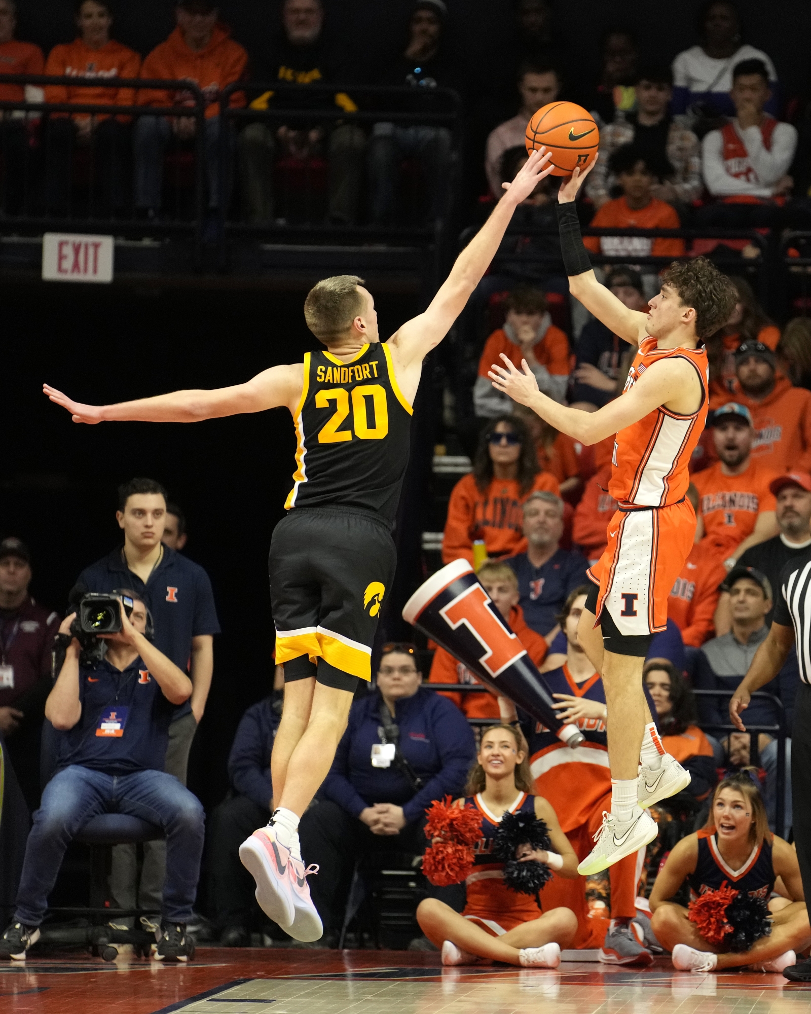 Illinois' Niccolo Moretti, right, shoots over Iowa's Payton Sandfort during the second half of an NCAA college basketball game Saturday, Feb. 24, 2024, in Champaign, Ill. Illinois won 95-85. (AP Photo/Charles Rex Arbogast)