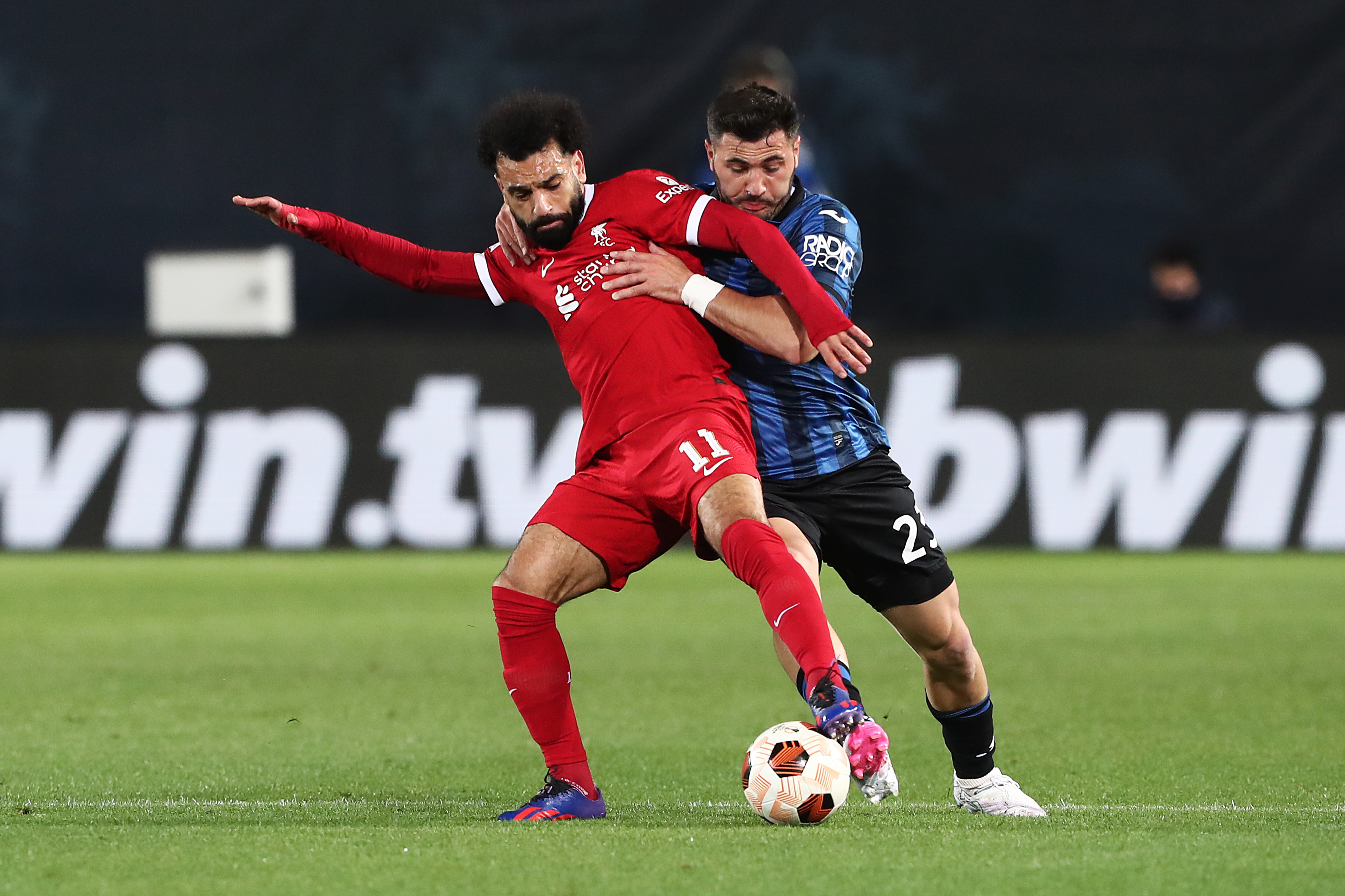 BERGAMO, ITALY - APRIL 18: Mohamed Salah of Liverpool is challenged by Sead Kolasinac of Atalanta BC during the UEFA Europa League 2023/24 Quarter-Final second leg match between Atalanta and Liverpool FC at Stadio Atleti Azzurri d'Italia on April 18, 2024 in Bergamo, Italy. (Photo by Marco Luzzani/Getty Images)