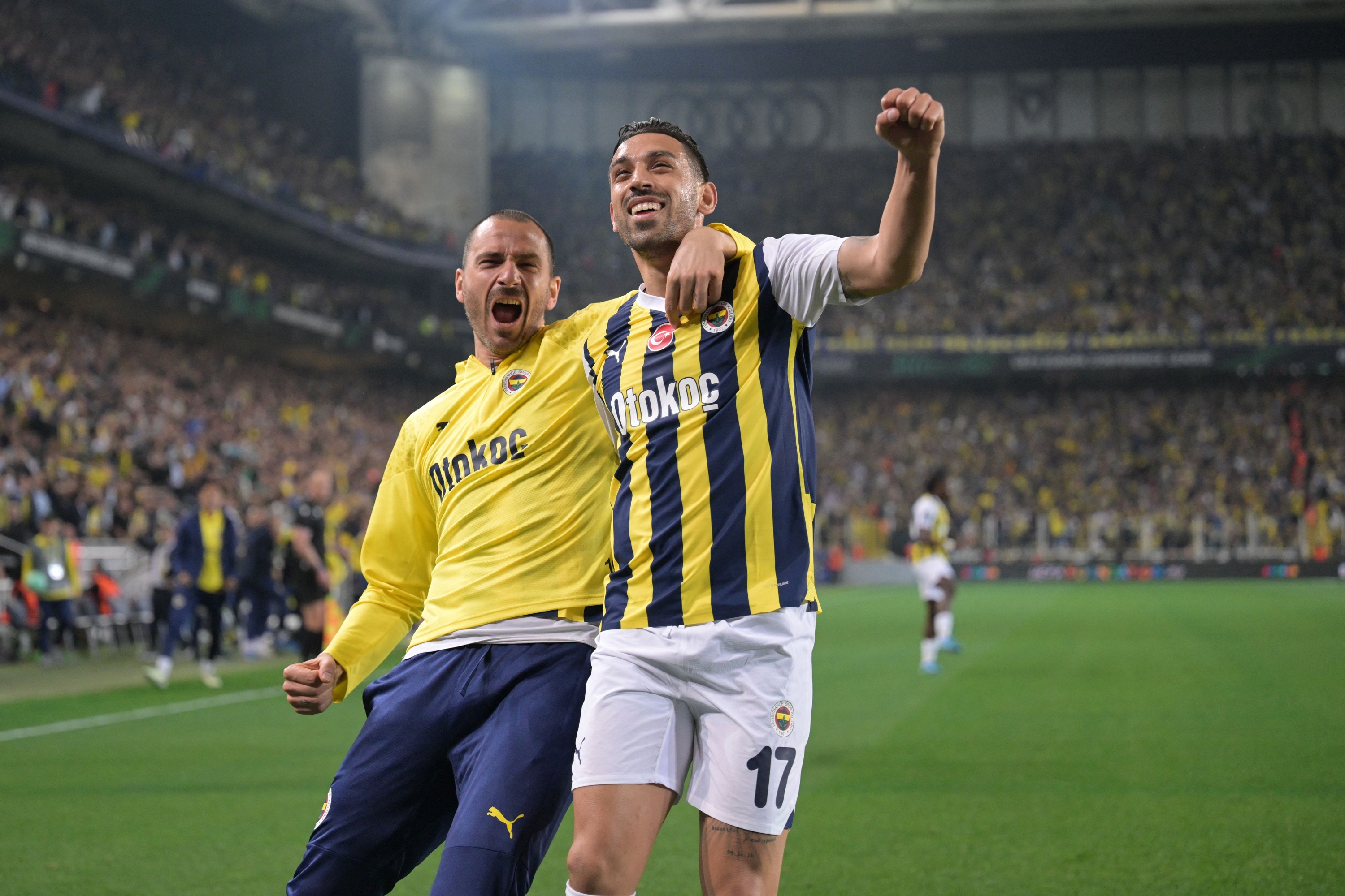 Fenerbahce's Turkish midfielder Irfan #17 Can Kahveci celebrates with his teammate Italian defender #19 Leonardo Bonucci (L) after scoring a goal during the UEFA Europa Conference League quarter-final second leg football match between Fenerbahce (TUR) and Olympiakos (GRE) at the Fenerbahce Sukru Aracoglu Stadium,  in Istanbul on April 18, 2024. (Photo by Ozan KOSE / AFP)