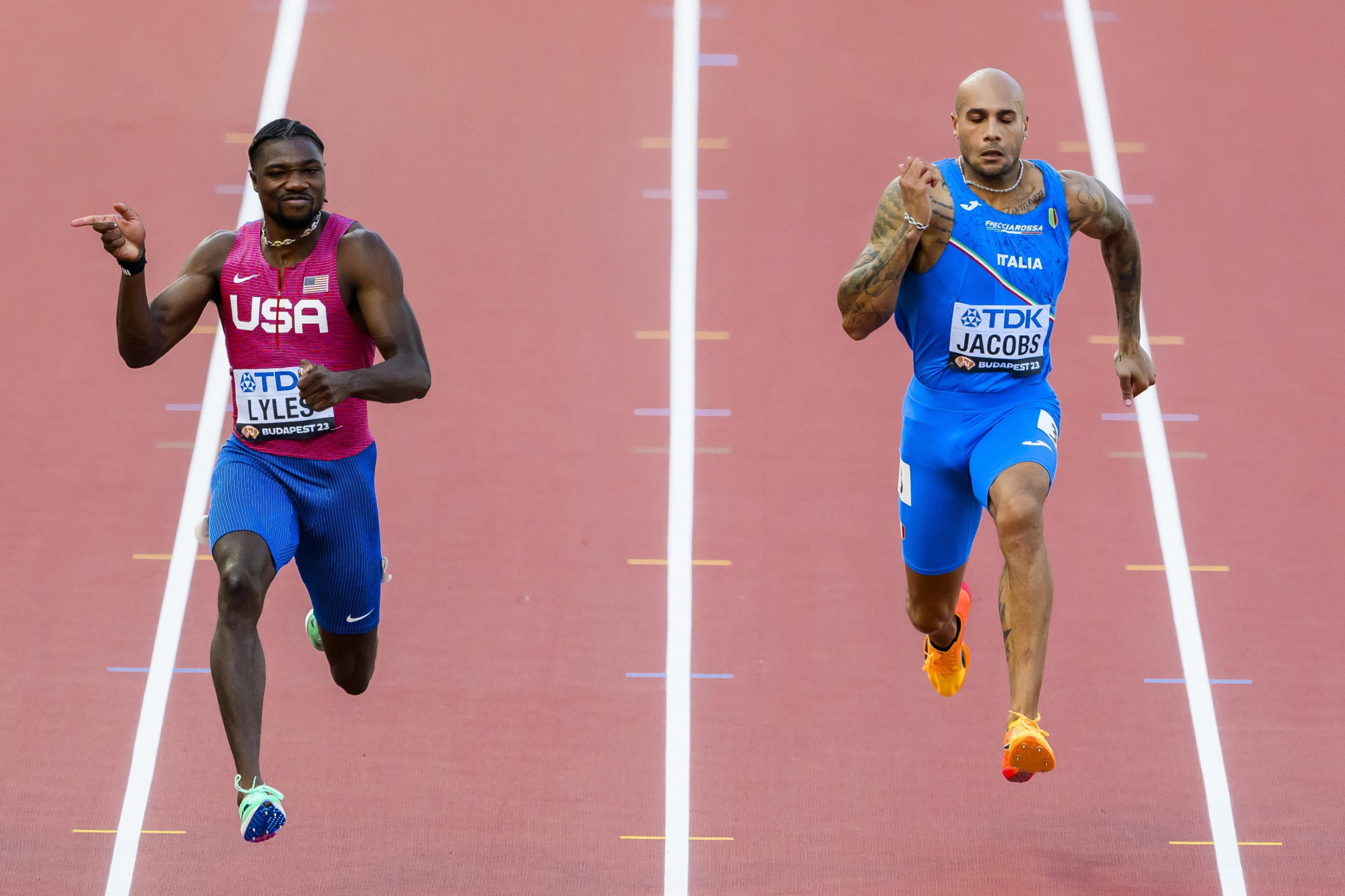 epa10810038 Noah Lyles (L) of the USA in action next to Lamont Marcell Jacobs of Italy during the men's 100 meters semi-final of the World Athletics Championships in Budapest, Hungary, 20 August 2023.  EPA/JEAN-CHRISTOPHE BOTT