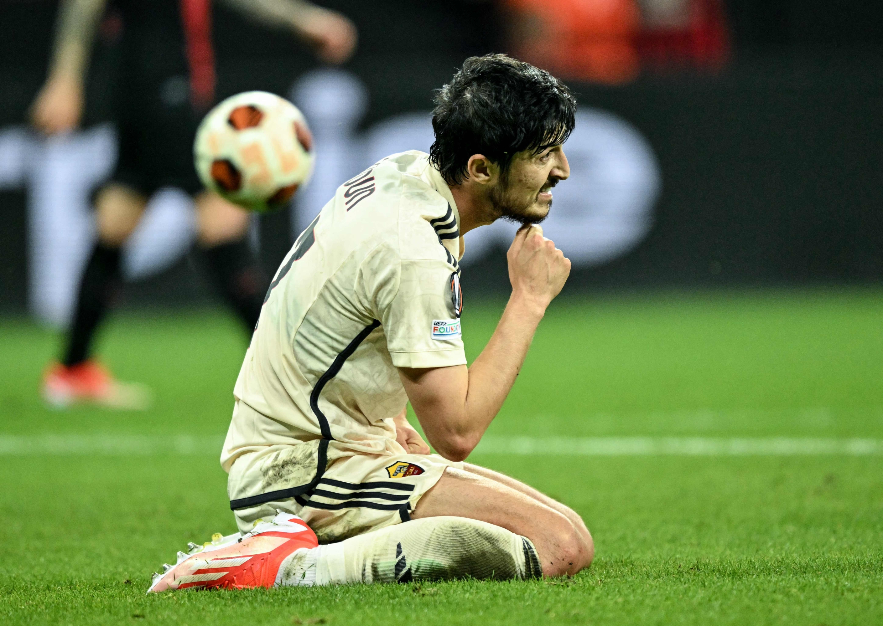 Roma's Iranian forward #17 Sardar Azmoun sits on the pitch during the UEFA Europa League semi final second leg football match between Bayer Leverkusen and ASC Roma in Leverkusen, on May 9, 2024. (Photo by INA FASSBENDER / AFP)