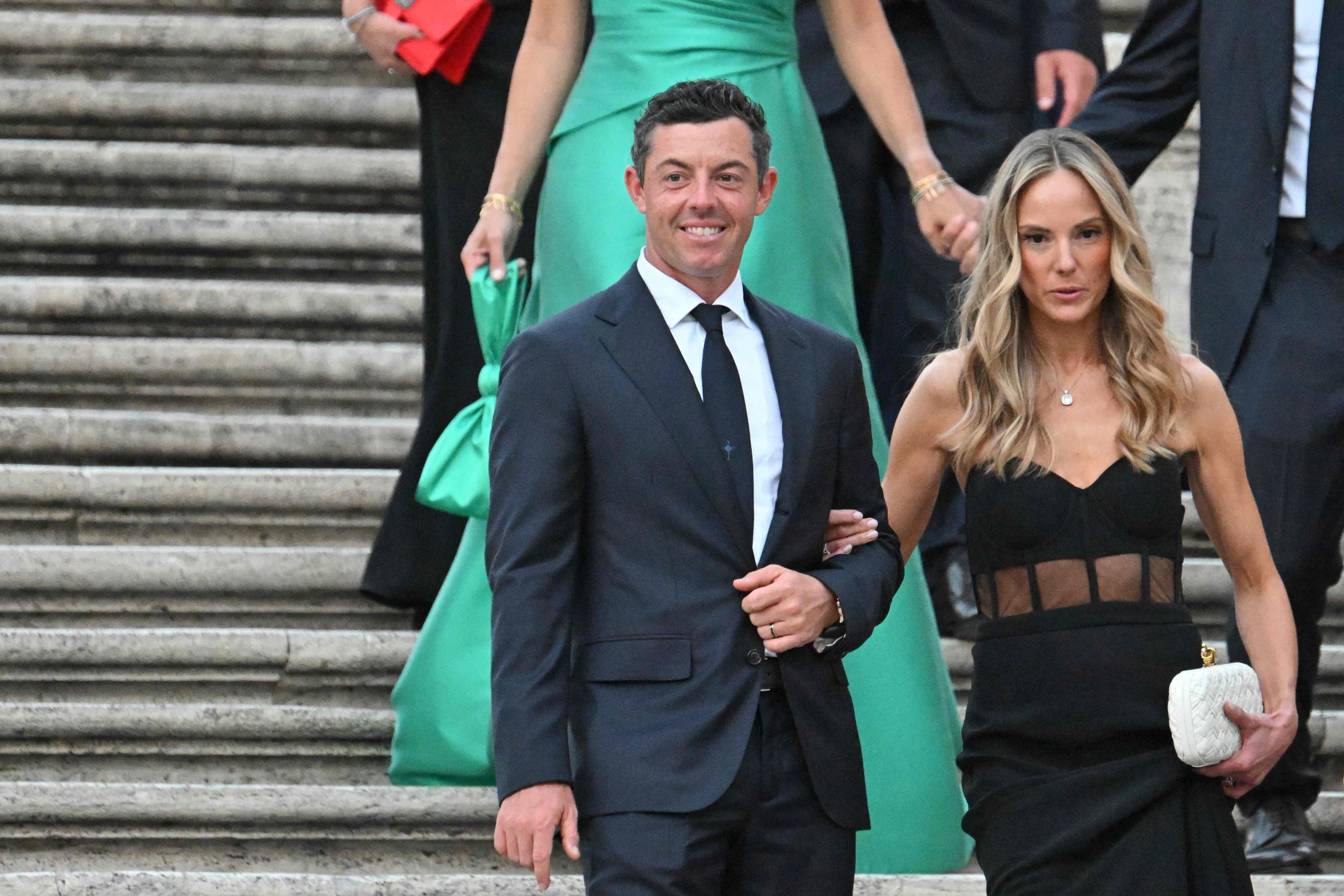 (FILES) Europe's Northern Irish golfer, Rory McIlroy (L) and wife Erica Stroll arrive for a team photo on the Spanish Steps after an official Team photo ahead of the 44th Ryder Cup at the Marco Simone Golf and Country Club in Rome on September 27, 2023. McIlroy has filed for divorce from wife Erica, submitting the documents on Monday in Florida to end their marriage after just over seven years, celebrity website TMZ reported on May 14, 2024. (Photo by Alberto PIZZOLI / AFP)