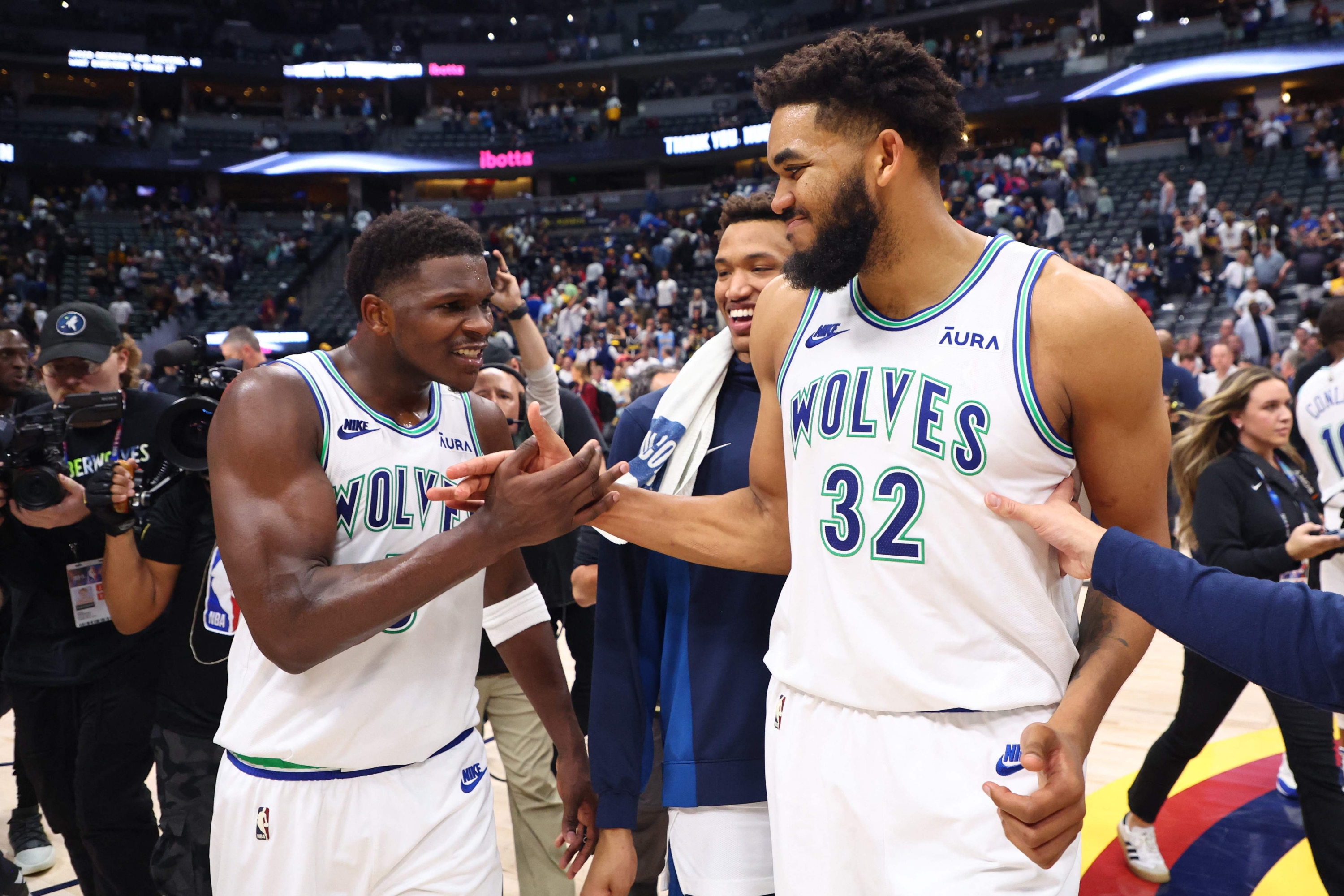 DENVER, COLORADO - MAY 19: Anthony Edwards #5 and Karl-Anthony Towns #32 of the Minnesota Timberwolves celebrate after winning Game Seven of the Western Conference Second Round Playoffs against the Denver Nuggets at Ball Arena on May 19, 2024 in Denver, Colorado. NOTE TO USER: User expressly acknowledges and agrees that, by downloading and or using this photograph, User is consenting to the terms and conditions of the Getty Images License Agreement.   C. Morgan Engel/Getty Images/AFP (Photo by C. Morgan Engel / GETTY IMAGES NORTH AMERICA / Getty Images via AFP)