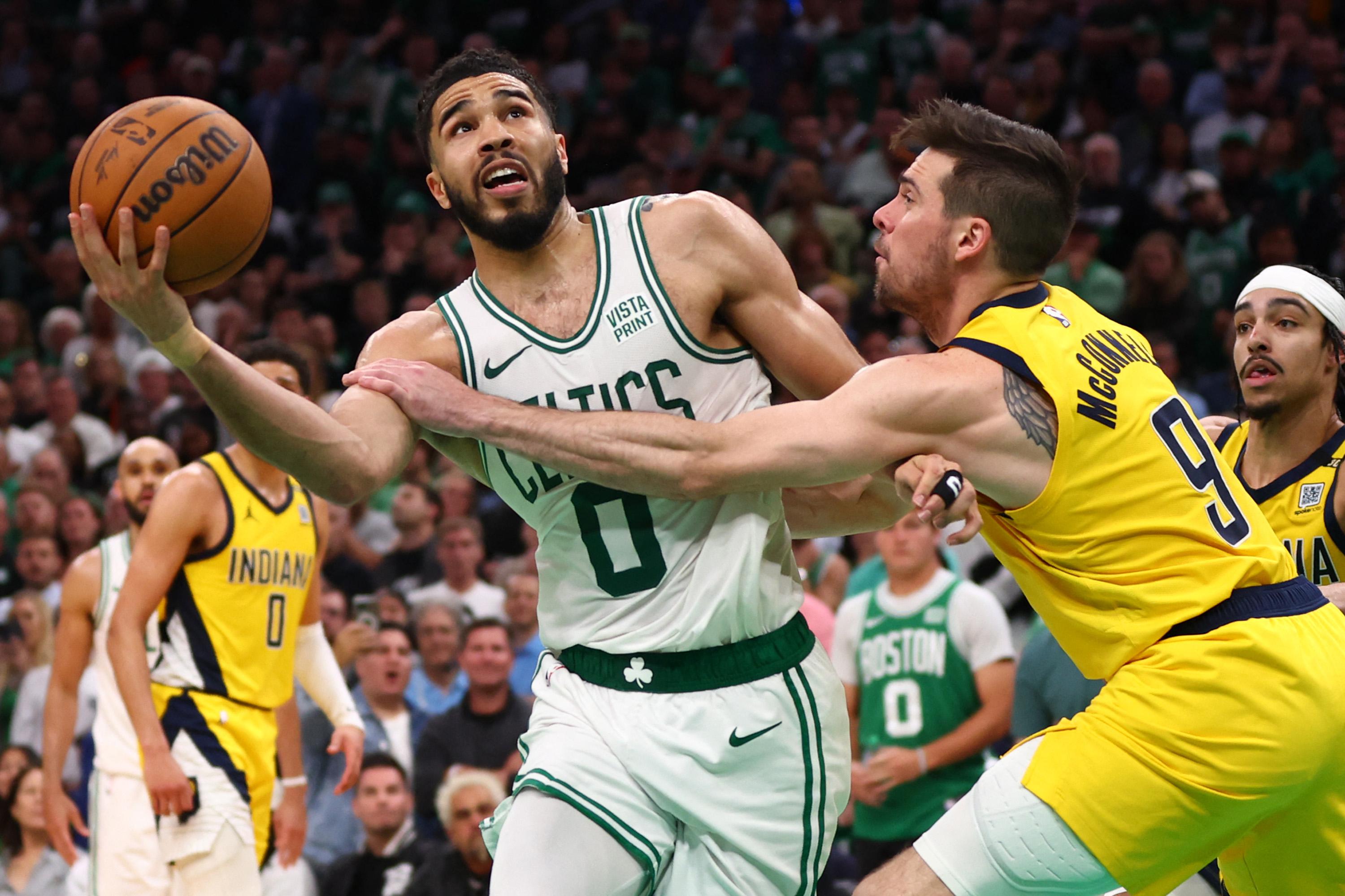 BOSTON, MASSACHUSETTS - MAY 21: Jayson Tatum #0 of the Boston Celtics is fouled by T.J. McConnell #9 of the Indiana Pacers during overtime in Game One of the Eastern Conference Finals at TD Garden on May 21, 2024 in Boston, Massachusetts. NOTE TO USER: User expressly acknowledges and agrees that, by downloading and or using this photograph, User is consenting to the terms and conditions of the Getty Images License Agreement.   Maddie Meyer/Getty Images/AFP (Photo by Maddie Meyer / GETTY IMAGES NORTH AMERICA / Getty Images via AFP)