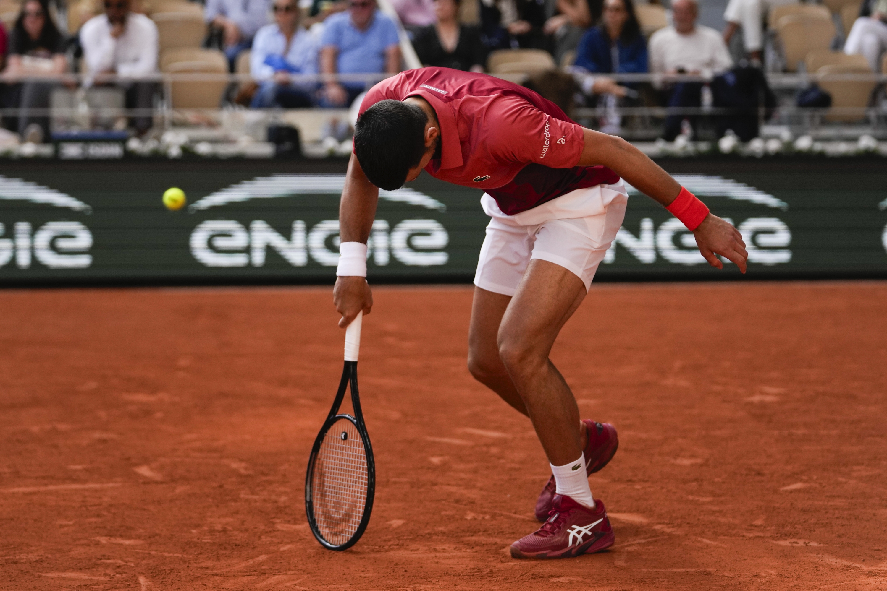 Serbia's Novak Djokovic reacts after missing a shot against Argentina's Francisco Cerundolo during their fourth round match of the French Open tennis tournament at the Roland Garros stadium in Paris, Monday, June 3, 2024. (AP Photo/Thibault Camus)