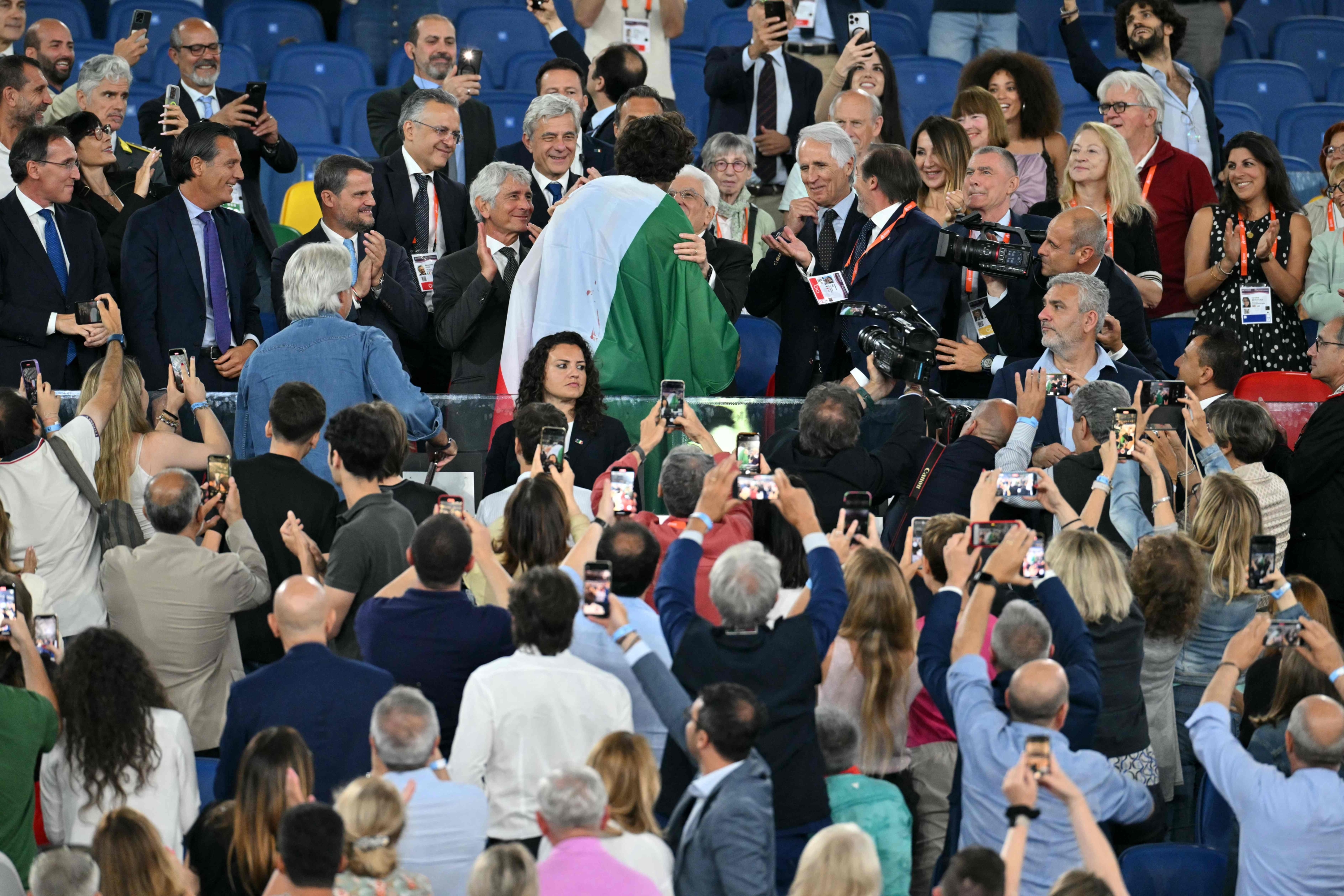 Italy's Gianmarco Tamberi celebrates with Italian President Sergio Mattarella after he won the men's high jump final during the European Athletics Championships at the Olympic stadium in Rome on June 11, 2024. (Photo by Andreas SOLARO / AFP)