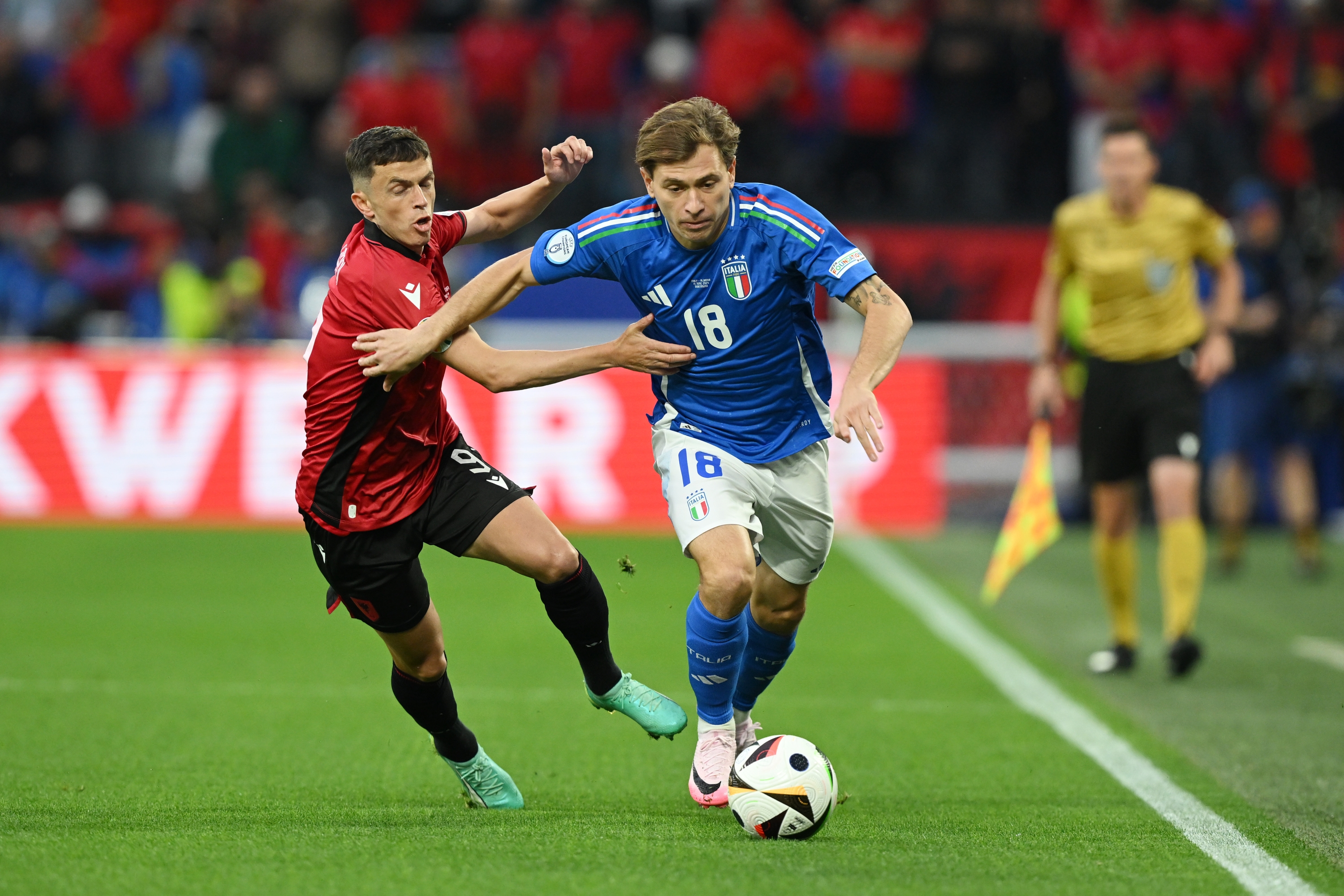 DORTMUND, GERMANY - JUNE 15: Nicolo Barella of Italy runs with the ball whilst under pressure from Jasir Asani of Albania during the UEFA EURO 2024 group stage match between Italy and Albania at Football Stadium Dortmund on June 15, 2024 in Dortmund, Germany. (Photo by Claudio Villa/Getty Images for FIGC)