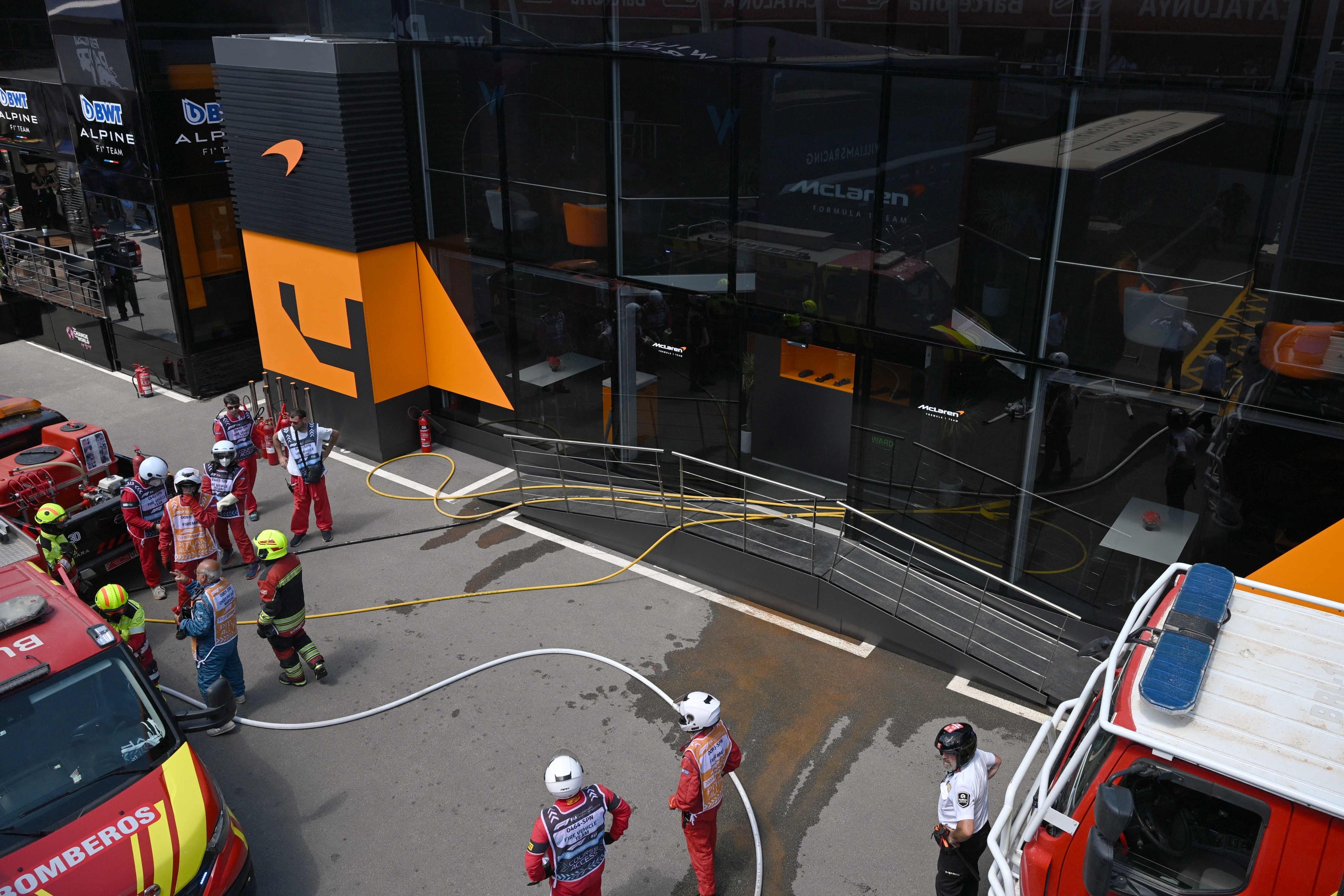 Firefighters work to extinguish a fire at McLaren motor-home at the Circuit de Catalunya on June 22, 2024 in Montmelo, on the outskirts of Barcelona, during the Spanish Formula One Grand Prix. (Photo by Josep LAGO / AFP)