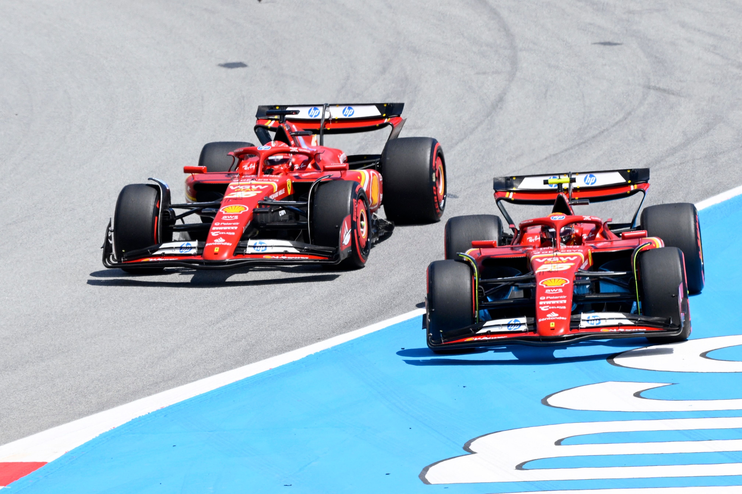 Ferrari's Spanish driver Carlos Sainz (R) overtakes Ferrari's Monegasque driver Charles Leclerc during the Spanish Formula One Grand Prix at the Circuit de Catalunya on June 23, 2024 in Montmelo, on the outskirts of Barcelona. (Photo by Josep LAGO / AFP)