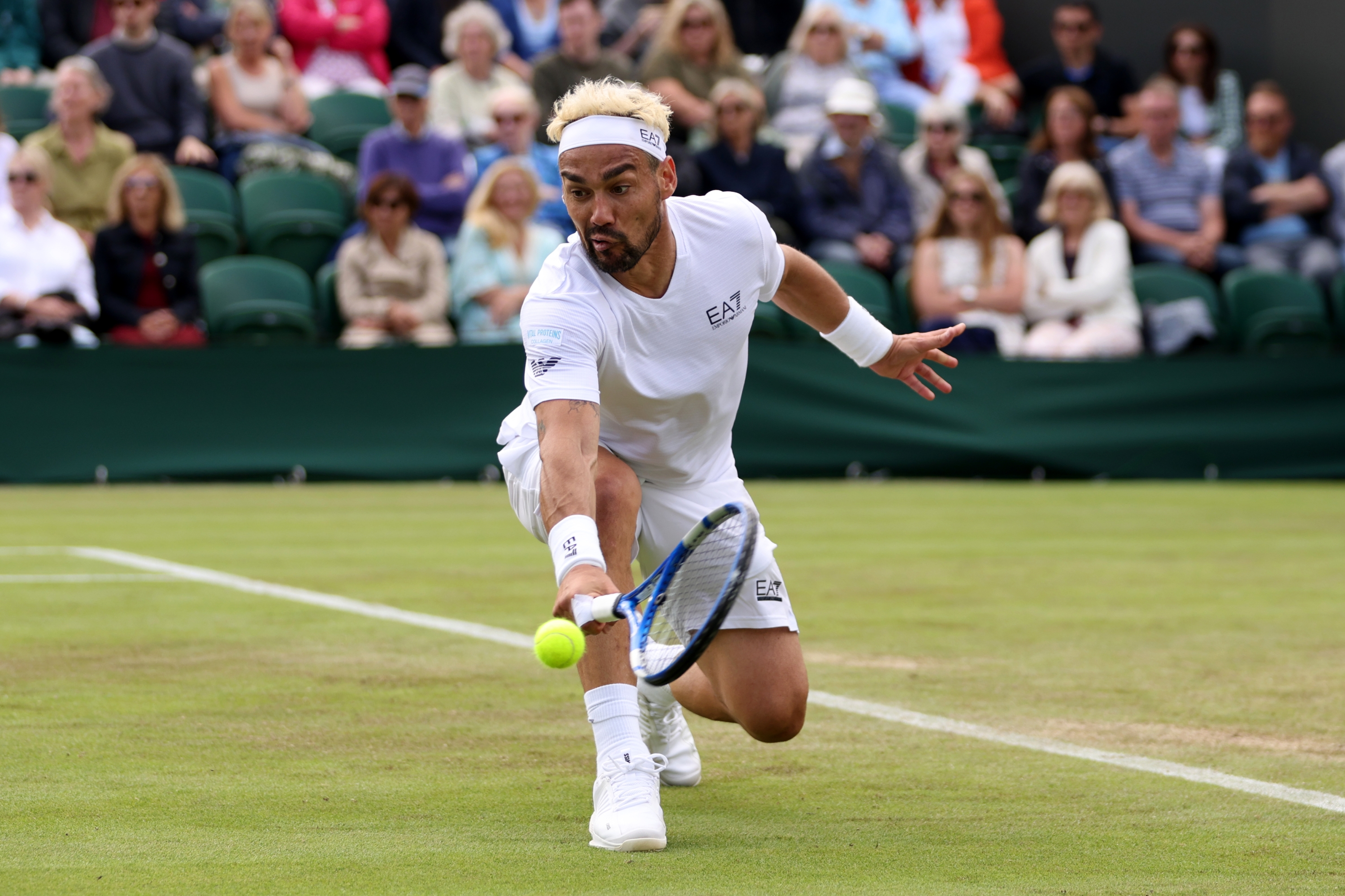 LONDON, ENGLAND - JULY 03: Fabio Fognini of Italy plays a backhand against Casper Ruud of Norway in his Men's Singles second round match during day three of The Championships Wimbledon 2024 at All England Lawn Tennis and Croquet Club on July 03, 2024 in London, England. (Photo by Clive Brunskill/Getty Images)