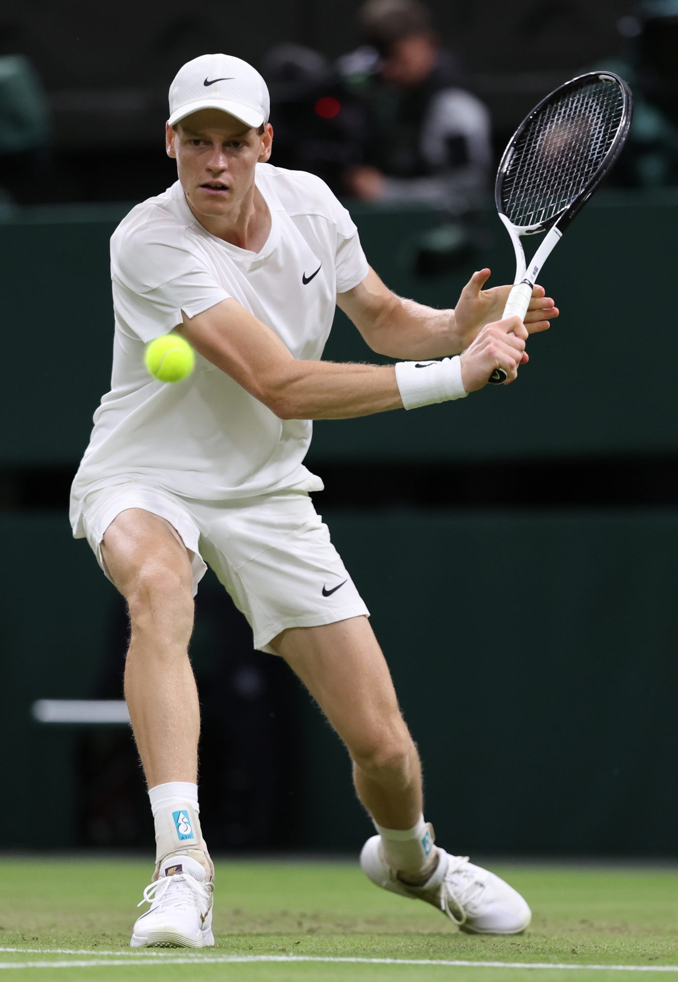 LONDON, ENGLAND - JULY 03: Jannik Sinner of Italy plays a backhand against Matteo Berrettini of Italy in his Gentlemen's Singles second round match during day three of The Championships Wimbledon 2024 at All England Lawn Tennis and Croquet Club on July 03, 2024 in London, England. (Photo by Clive Brunskill/Getty Images)