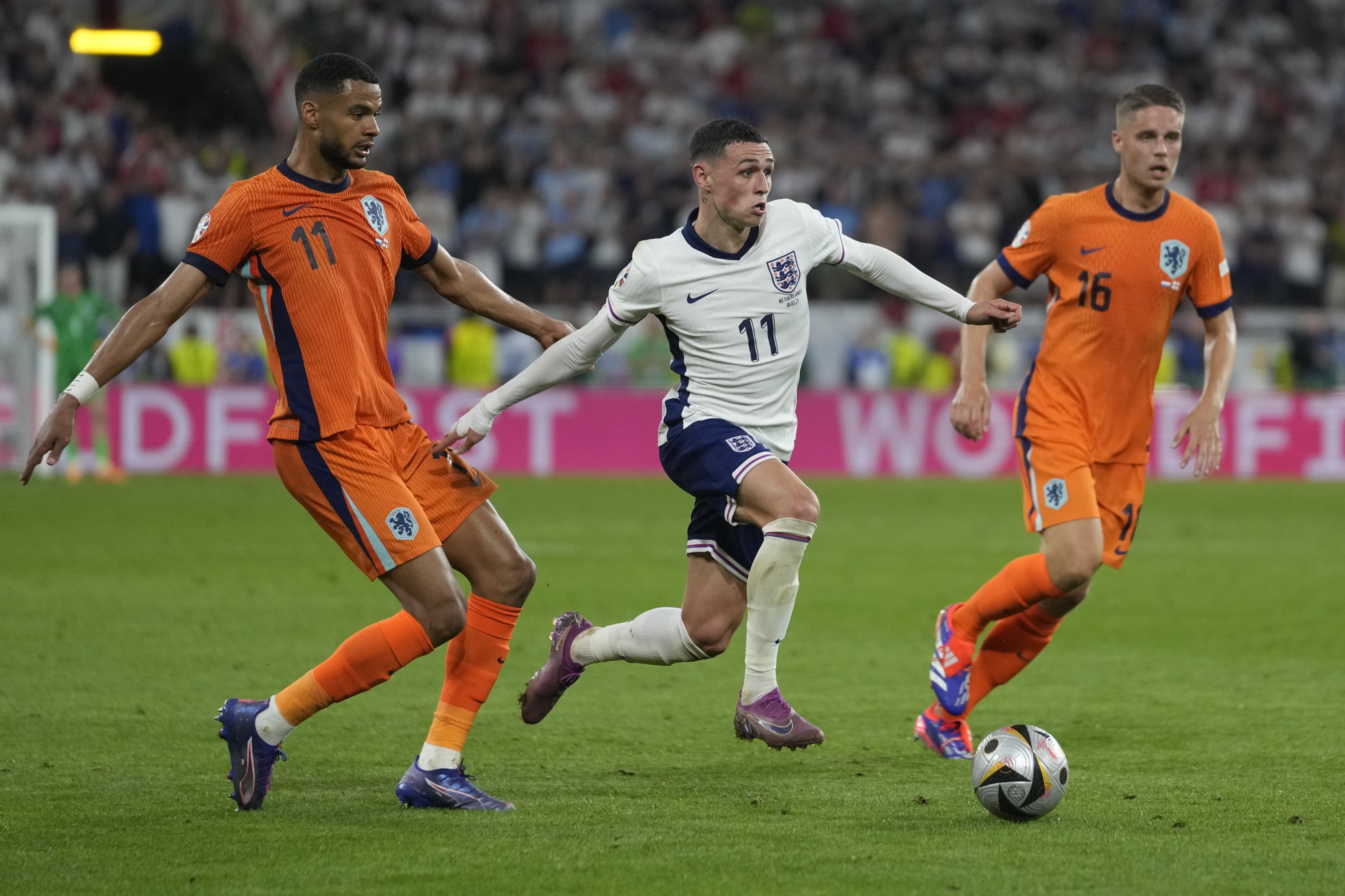 England's Phil Foden, centre, Cody Gakpo of the Netherlands, left, and Joey Veerman of the Netherlands during a semifinal match between the Netherlands and England at the Euro 2024 soccer tournament in Dortmund, Germany, Wednesday, July 10, 2024. (AP Photo/Darko Vojinovic)