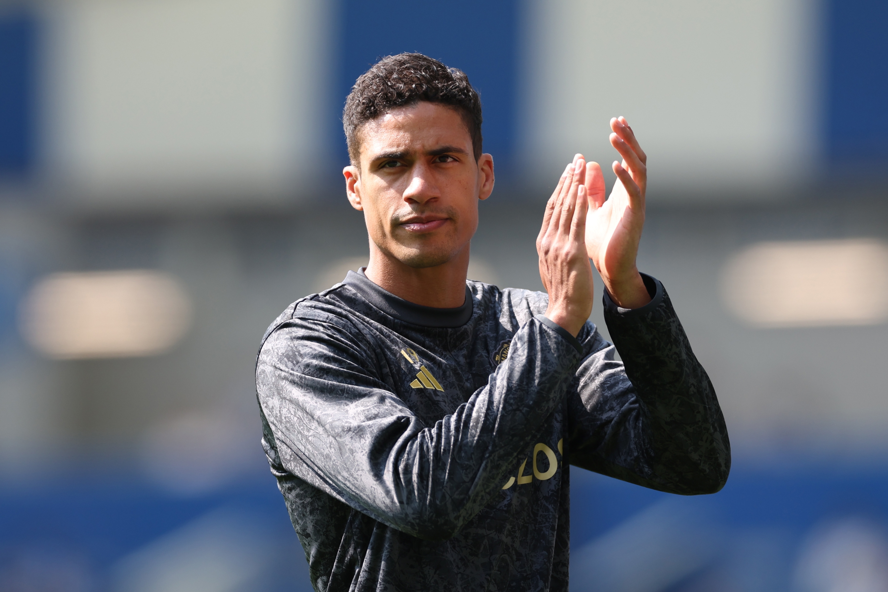 BRIGHTON, ENGLAND - MAY 19: Raphael Varane of Manchester United applauds the fans during the warm up prior to the Premier League match between Brighton & Hove Albion and Manchester United at American Express Community Stadium on May 19, 2024 in Brighton, England. (Photo by Michael Steele/Getty Images)