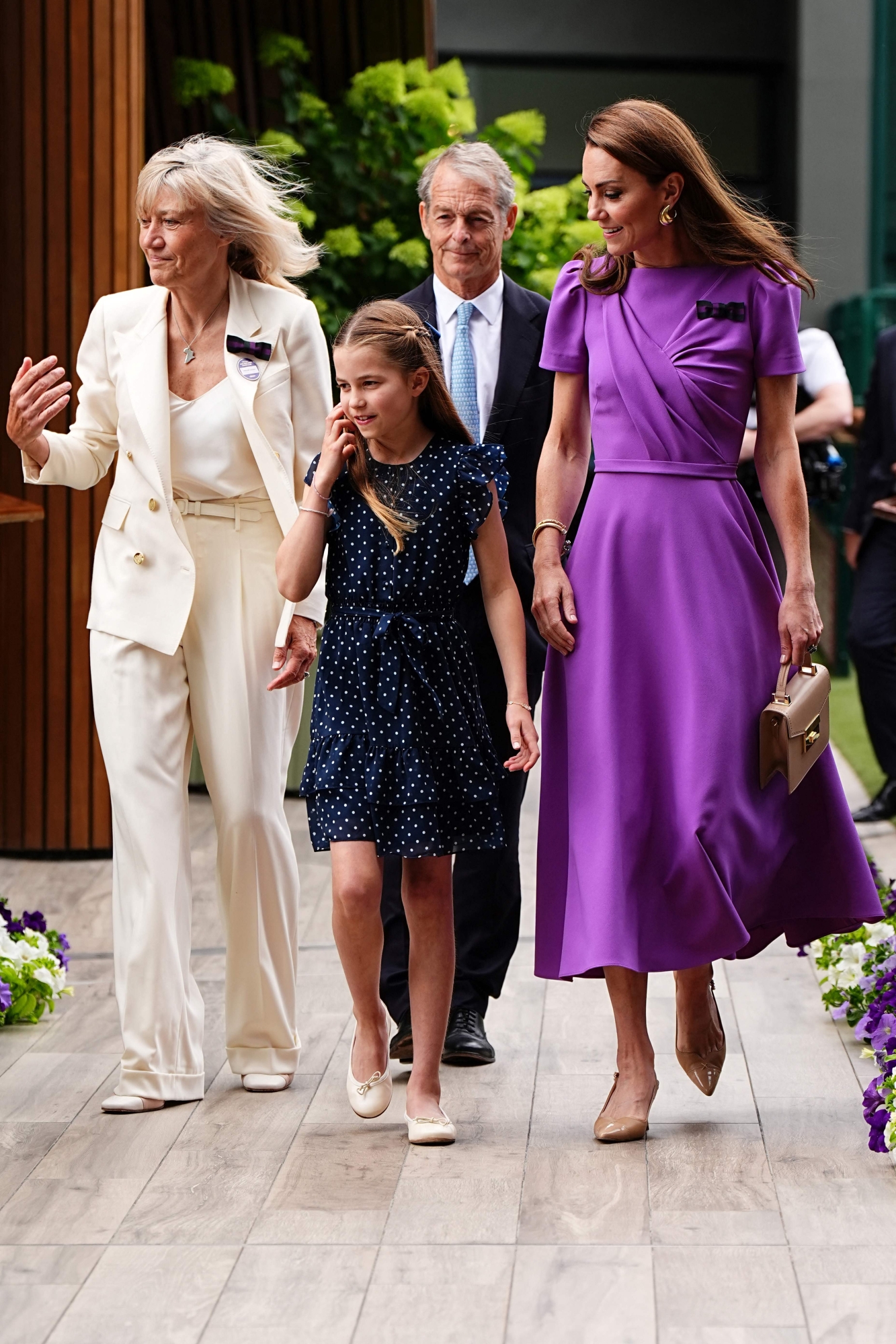 Britain's Catherine, Princess of Wales, (R) and her daughter Britain's Princess Charlotte of Wales (C) arrive to attend the men's singles final tennis match on the fourteenth day of the 2024 Wimbledon Championships at The All England Lawn Tennis and Croquet Club in Wimbledon, southwest London, on July 14, 2024. (Photo by Aaron Chown / POOL / AFP) / RESTRICTED TO EDITORIAL USE