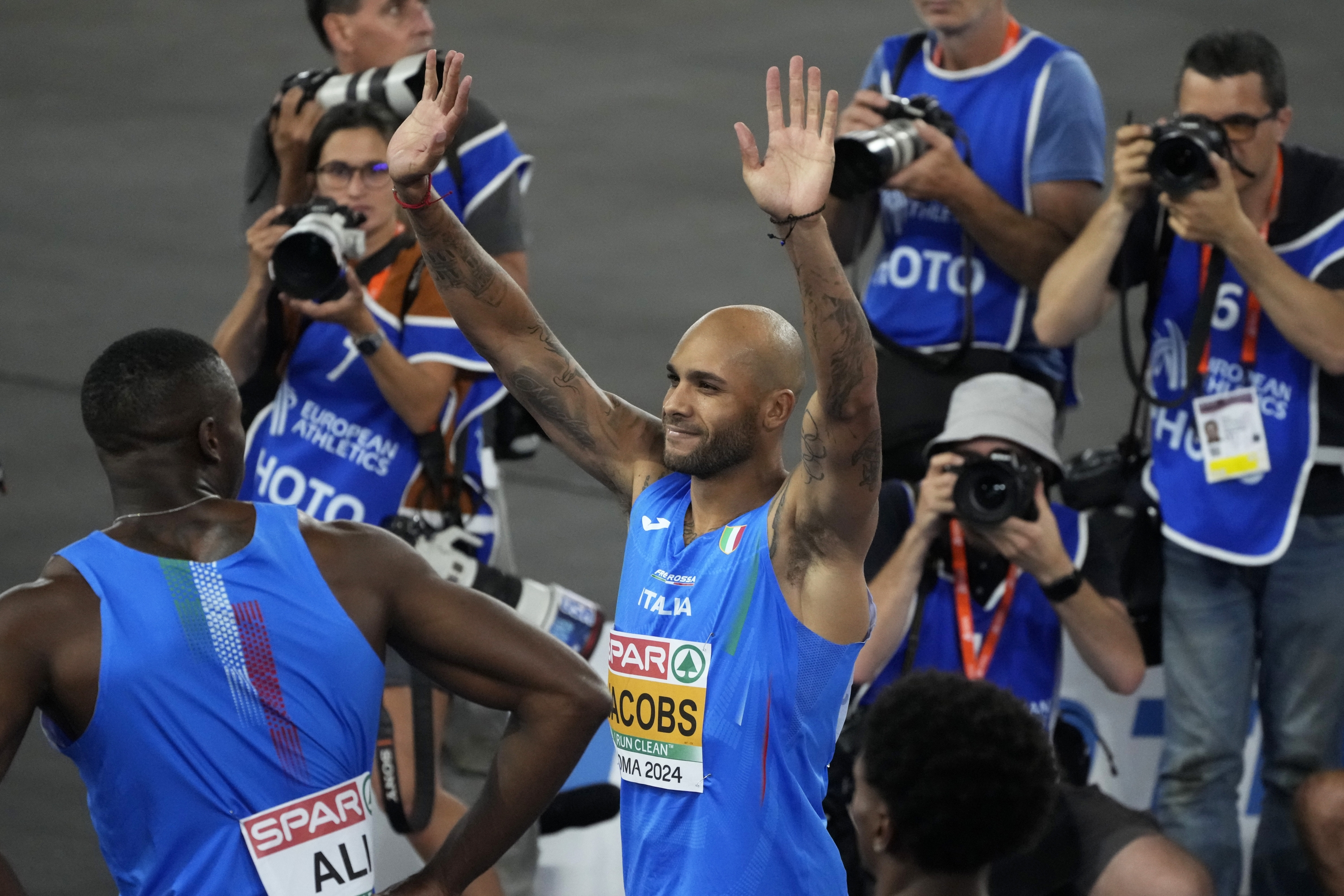 FILE - Lamont Marcell Jacobs, of Italy, celebrates after winning the gold medal in the men's 100 meters final at the the European Athletics Championships in Rome, Saturday, June 8, 2024. At the last two Olympics ? one summer, one winter ? there were no crowds because of the COVID pandemic. In Paris this summer, once again, all those fans, family members and the burst of energy they bring to all the fun and games will be back. (AP Photo/Gregorio Borgia, File)