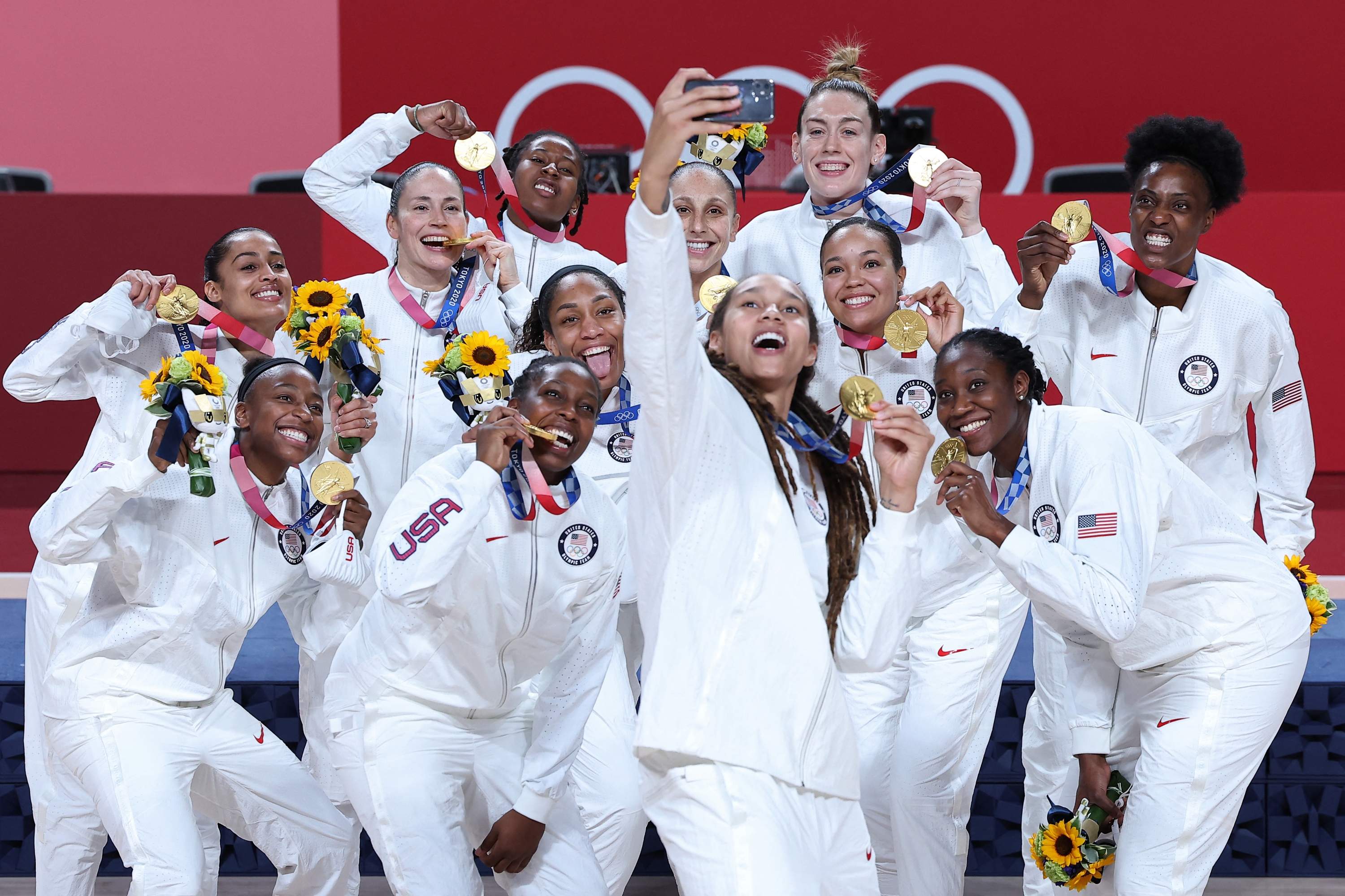First placed USA's players pose for a selfie with their gold medals during the medal ceremony for the women's basketball competition of the Tokyo 2020 Olympic Games at the Saitama Super Arena in Saitama on August 8, 2021. (Photo by Thomas COEX / AFP)