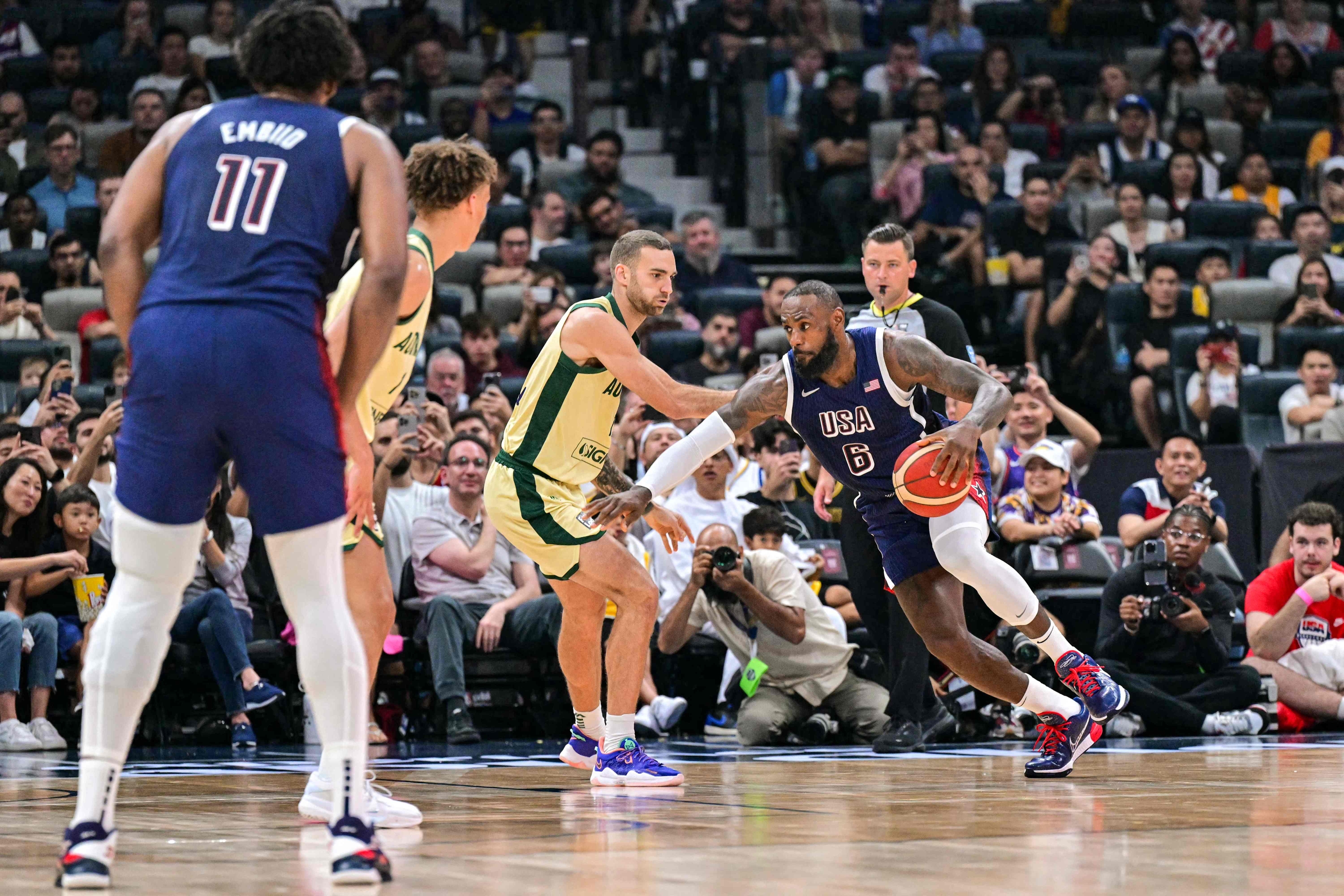 Australia's guard Jack McVeigh marks USA's forward #06 LeBron James during the Basketball Showcase friendly match between the United States and Australia at Etihad Arena in Abu Dhabi on July 15, 2024. (Photo by Giuseppe CACACE / AFP)