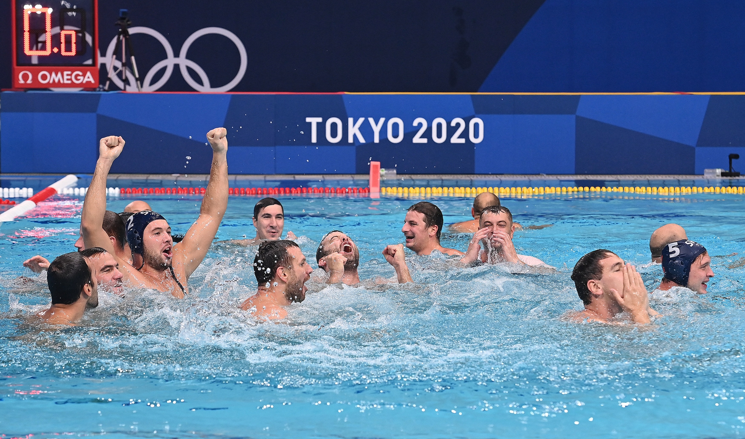 Gold medallists Serbia celebrate in the pool after winning the Tokyo 2020 Olympic Games men's water polo gold medal match between Greece and Serbia at the Tatsumi Water Polo Centre in Tokyo on August 8, 2021. (Photo by Angela WEISS / AFP)