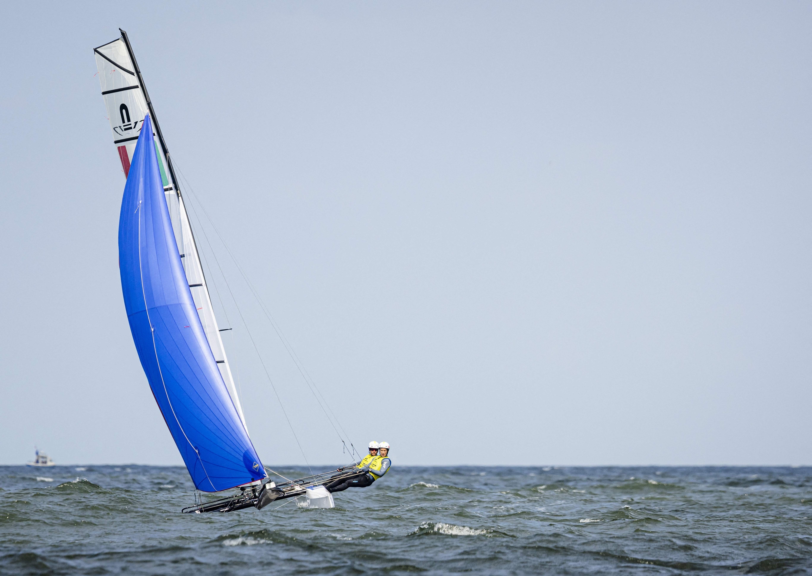 TOPSHOT - Caterina Banti and Ruggero Tita of Italy compete to win the gold medal in Nacra 17 World Championship in Scheveningen, The Hague, on August 17, 2023. (Photo by Sem van der Wal / ANP / AFP) / Netherlands OUT