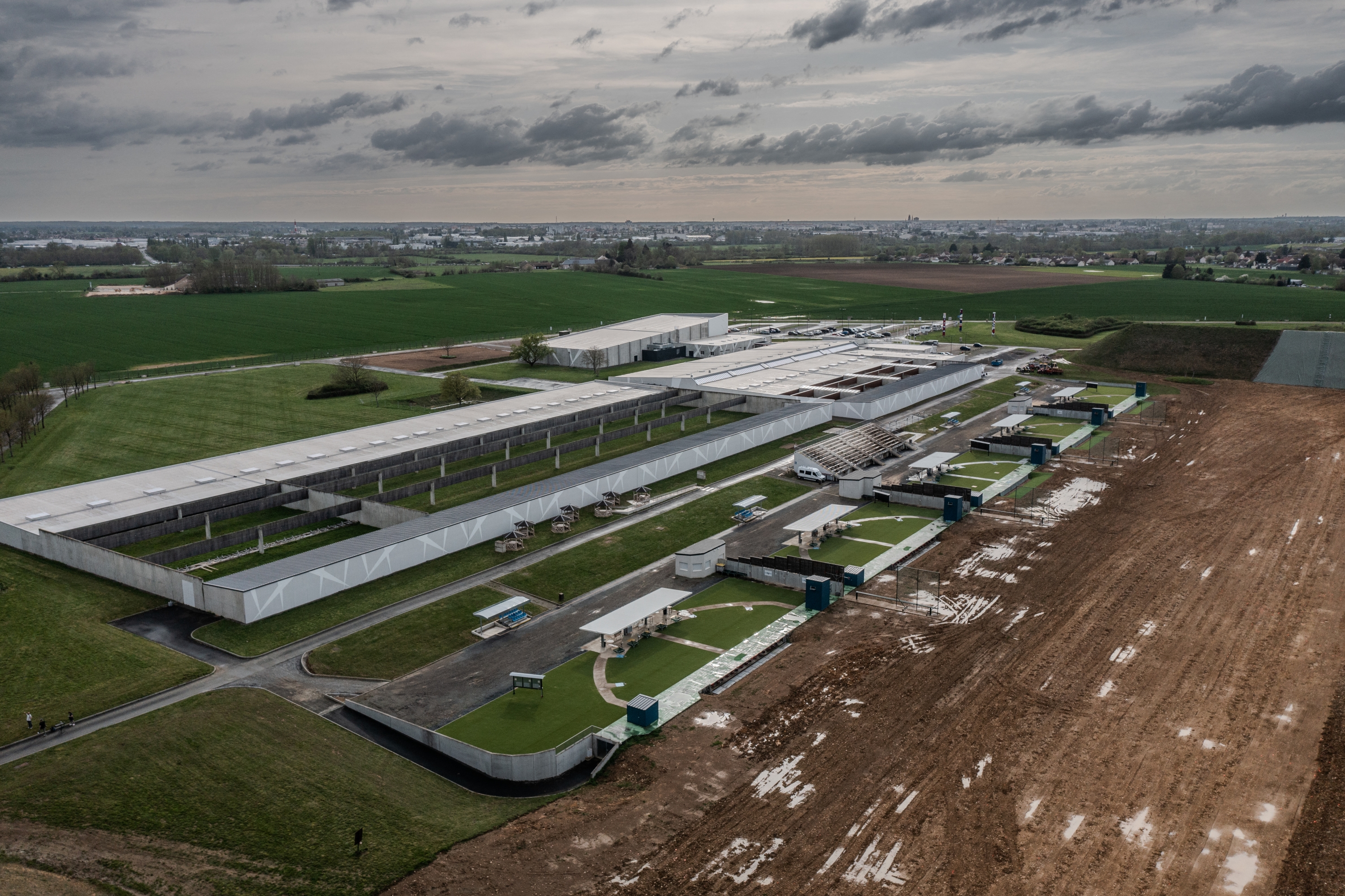 This aerial photograph taken on April 9, 2024 in Deols near Chateauroux, central France, shows the French National Shooting Center (CNTS), where the Paris 2024 Olympic Games shooting event will take place. (Photo by Martin BUREAU / AFP)