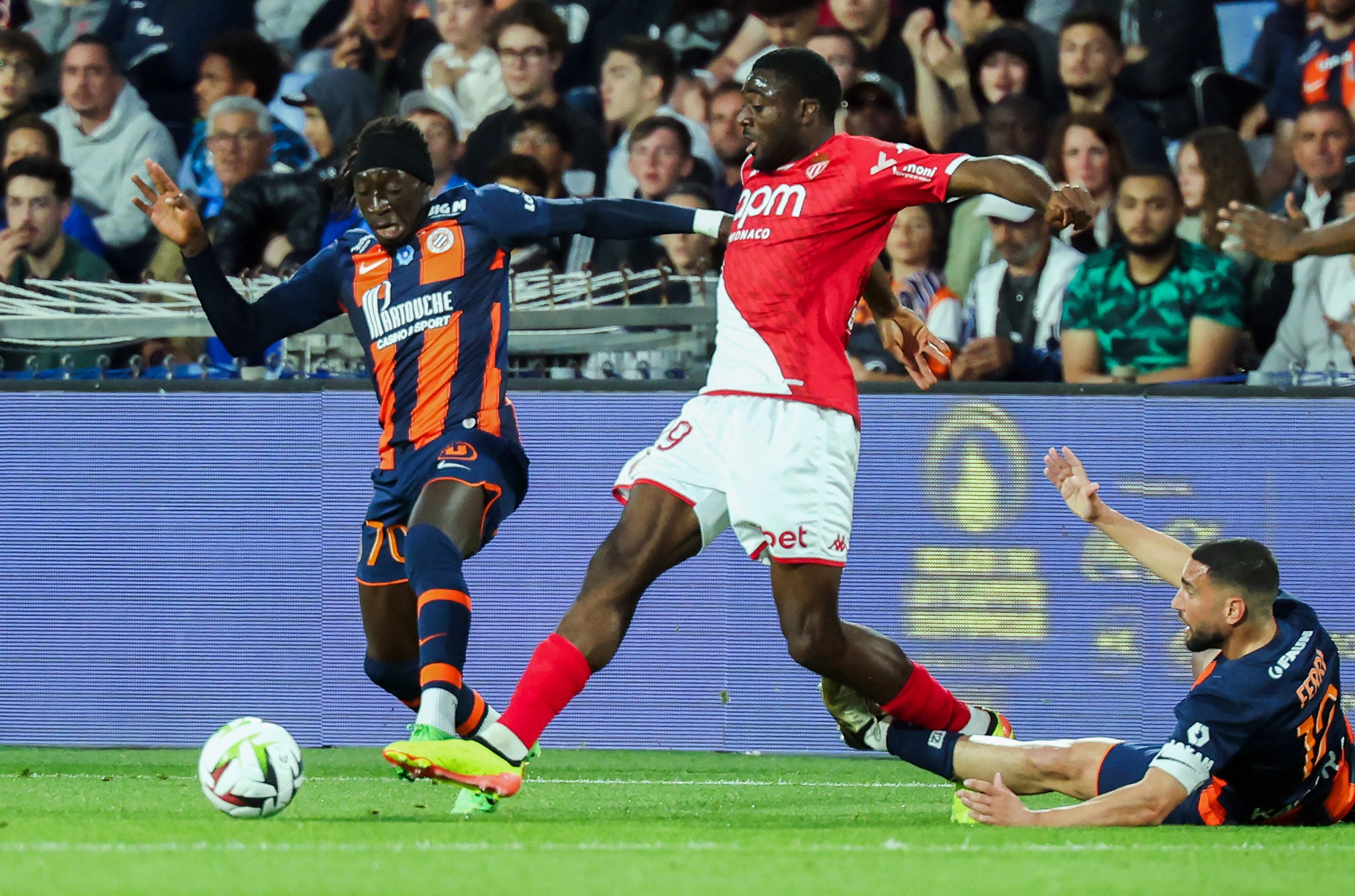 Monaco's French midfielder #19 Youssouf Fofana (C) fights for the ball with Montpellier's French forward #70 Tanguy Coulibaly (L) and Montpellier's French midfielder #12 Jordan Ferri (R) during the French L1 football match between Montpellier Herault SC and AS Monaco at Stade de la Mosson in Montpellier, southern France, on May 12, 2024. (Photo by Pascal GUYOT / AFP)