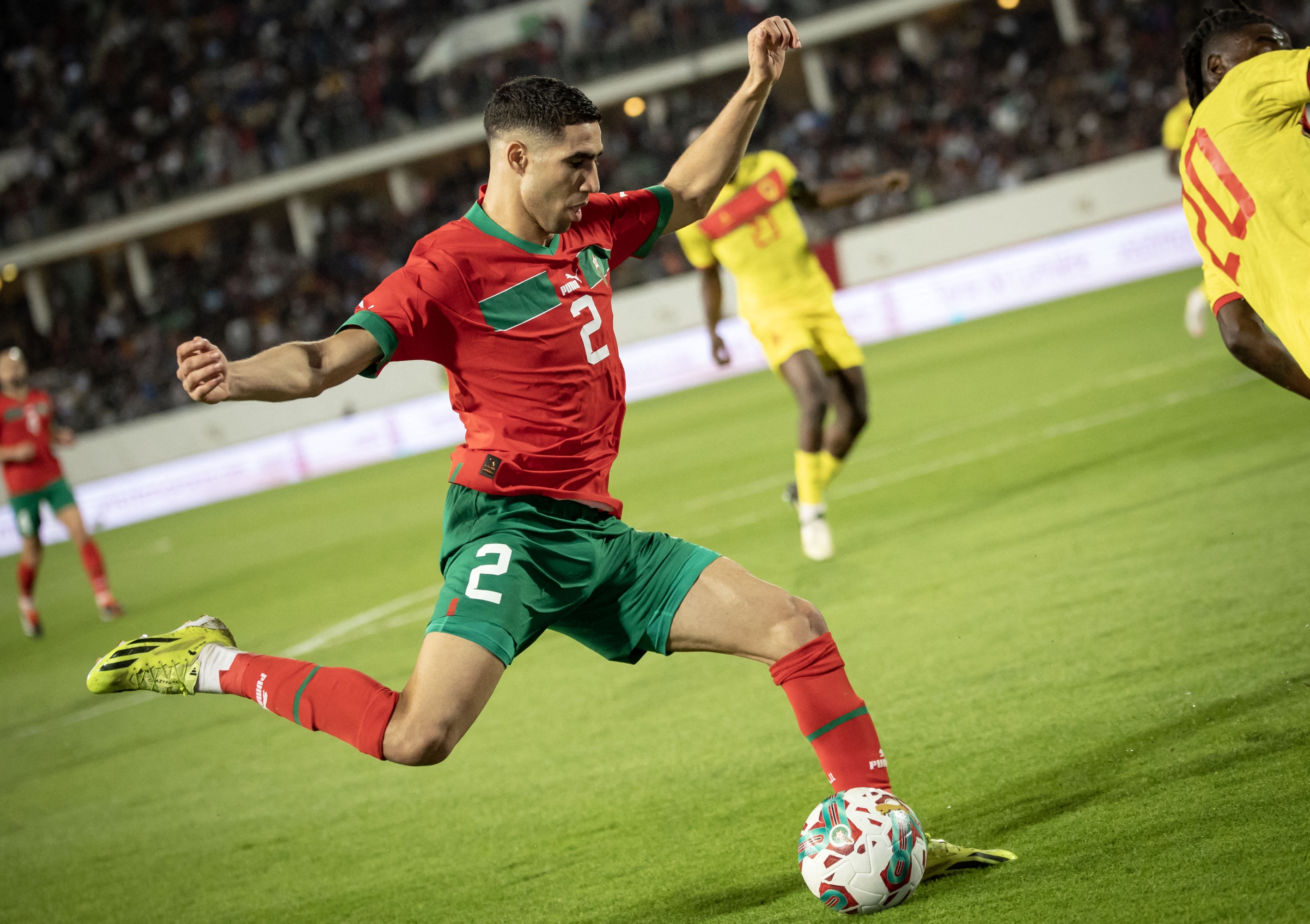 Morocco's defender #02 Achraf Hakimi goes to kick the ball during the international friendly football match between Morocco and Angola at Adrar Stadium in Agadir, Morocco, on March 22, 2024. (Photo by FADEL SENNA / AFP)