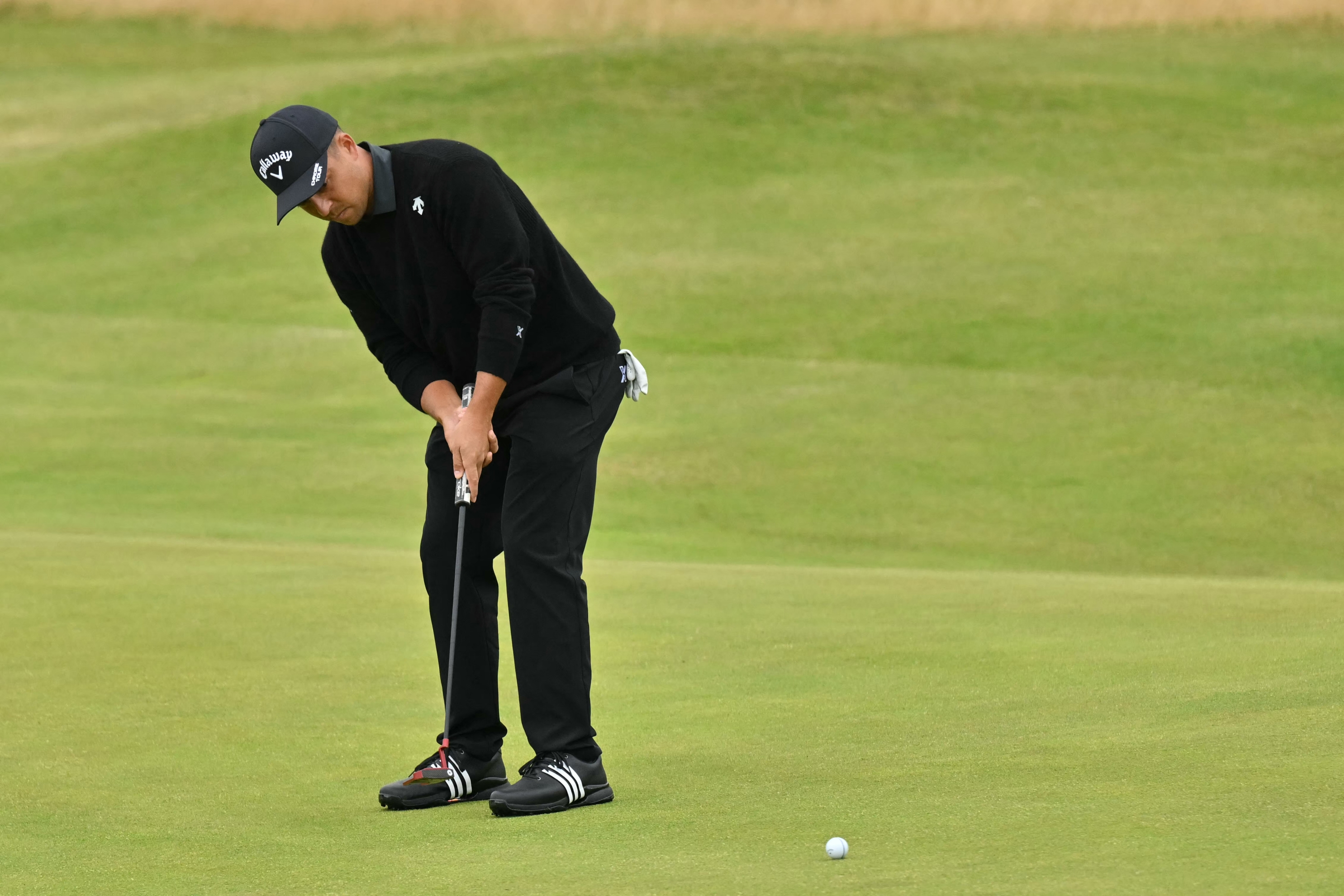 US golfer Xander Schauffele putts on the 12th green on the opening day of the 152nd British Open Golf Championship at Royal Troon on the south west coast of Scotland on July 18, 2024. (Photo by Glyn KIRK / AFP) / RESTRICTED TO EDITORIAL USE