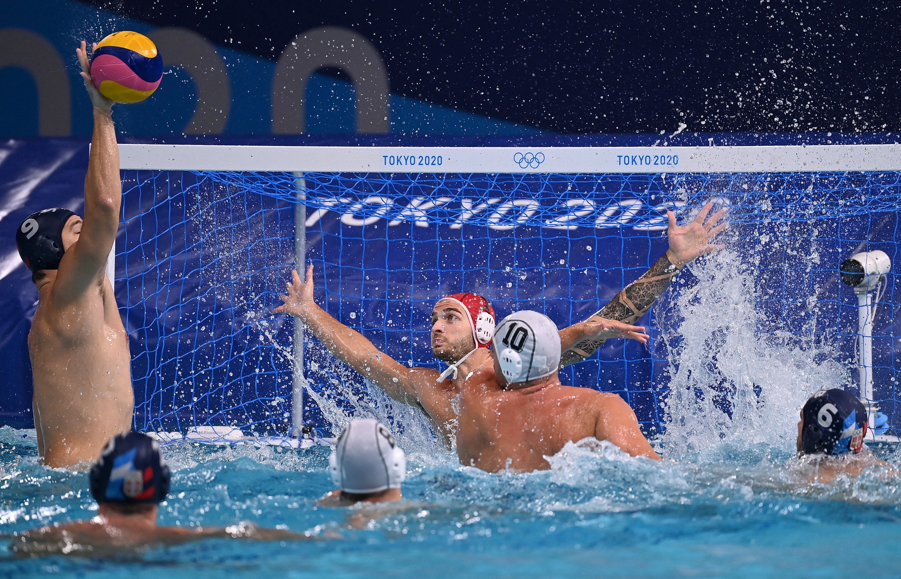 Serbia's Nikola Jaksic (L) shoots to score during the Tokyo 2020 Olympic Games men's water polo gold medal match between Greece and Serbia at the Tatsumi Water Polo Centre in Tokyo on August 8, 2021. (Photo by Angela WEISS / AFP)