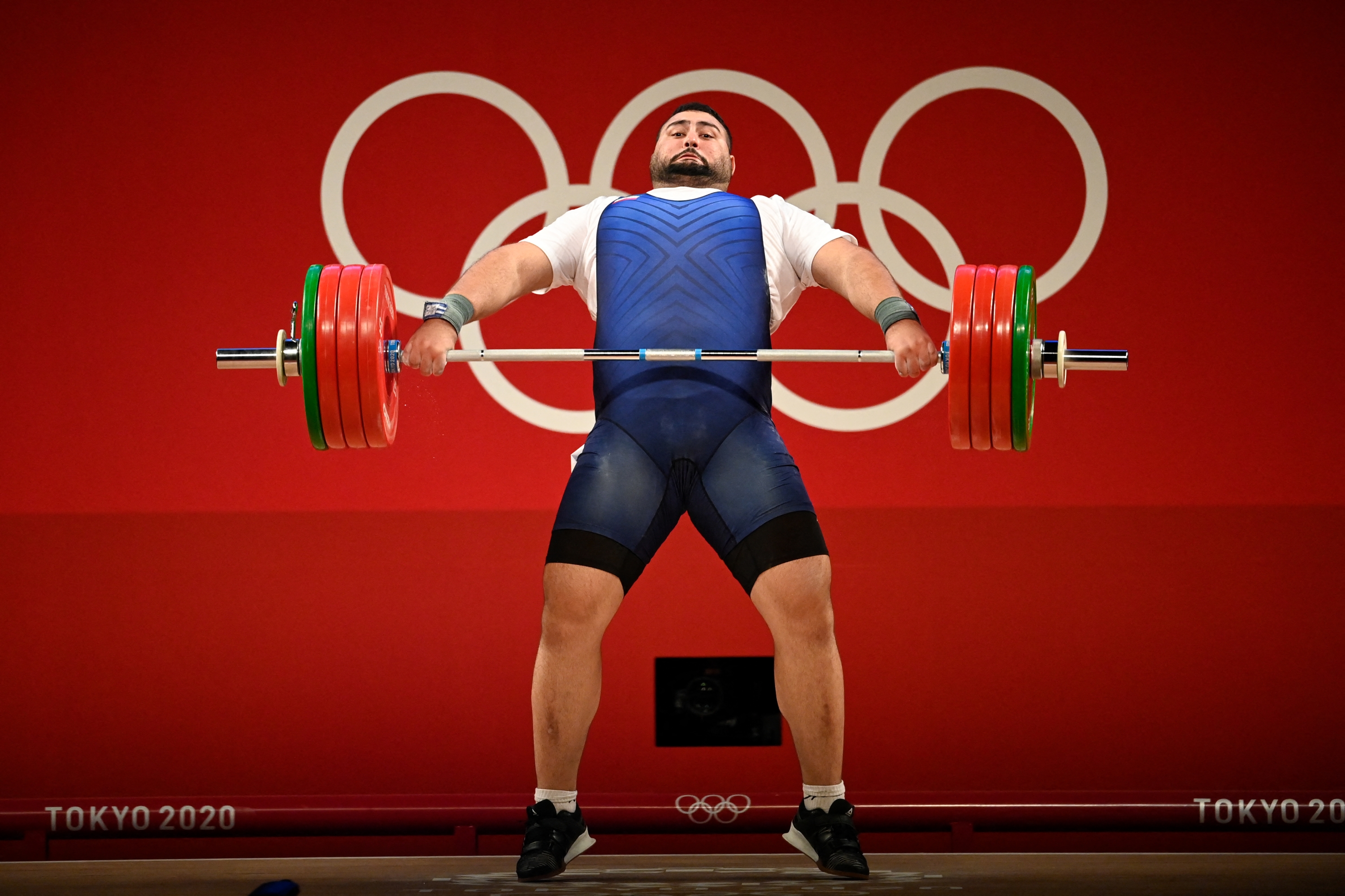 Iran's Ali Davoudi competes in the men's +109kg weightlifting competition during the Tokyo 2020 Olympic Games at the Tokyo International Forum in Tokyo on August 4, 2021. (Photo by Alexander NEMENOV / AFP)